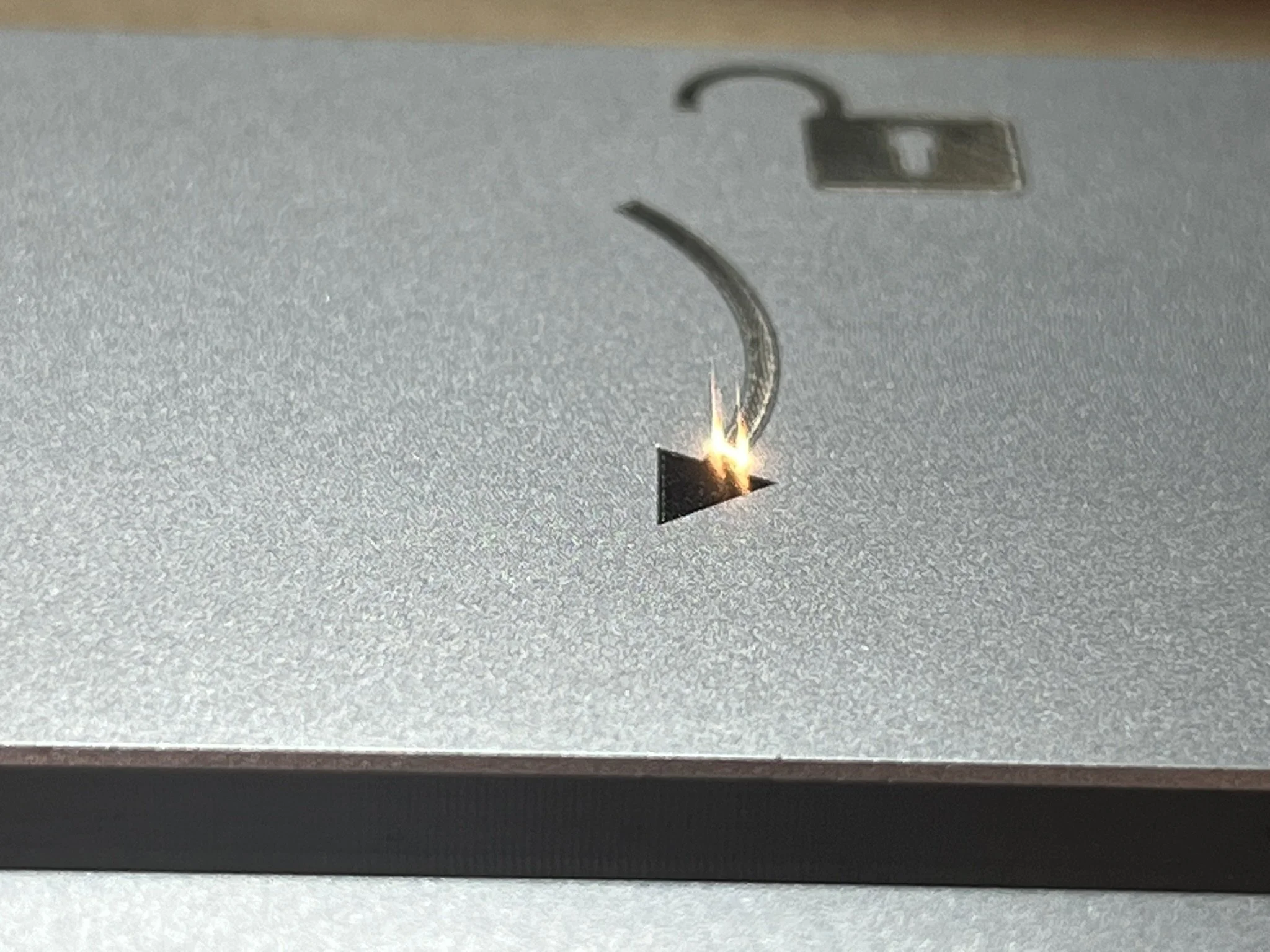 Laser marking identification detail on metal lighting component.