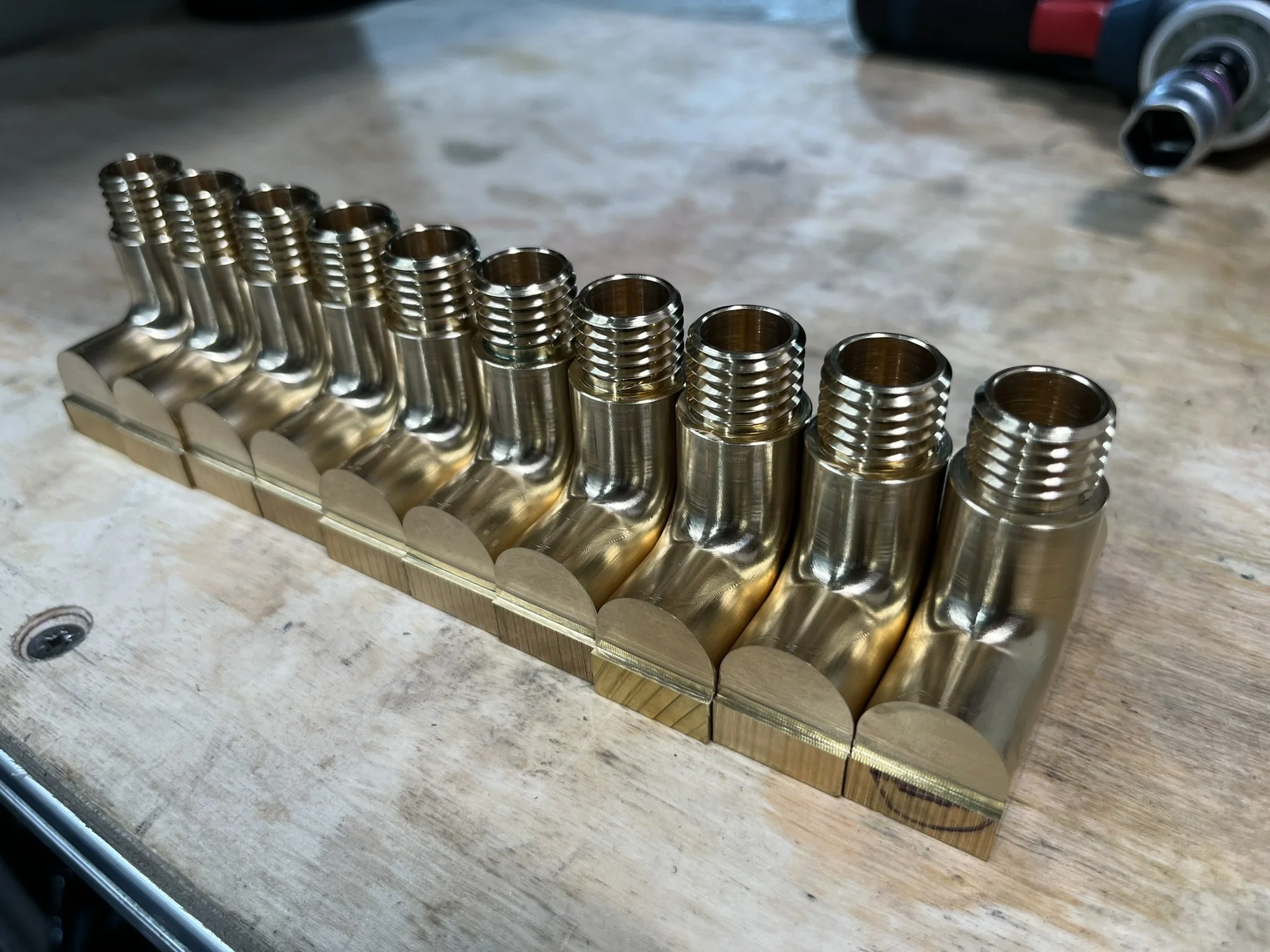 Initial machining operation on a small batch of custom brass light connectors, produced using both CNC milling and turning as part of a controlled manufacturing process.