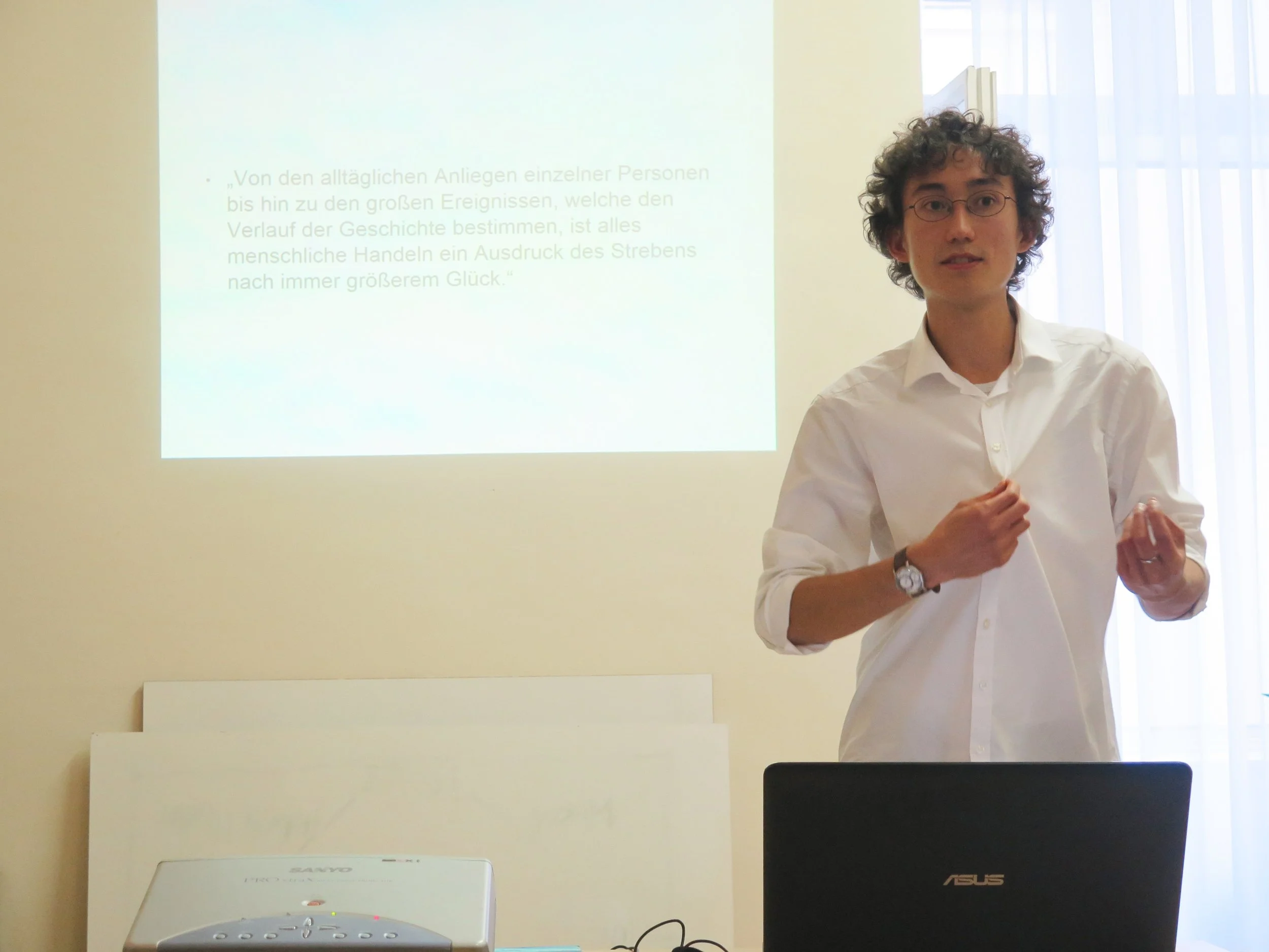 Akio Friesacher presenting on the principle, “We all ultimately want to experience joy.”