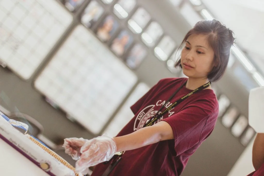 Harumi Muranaka working at the booth.