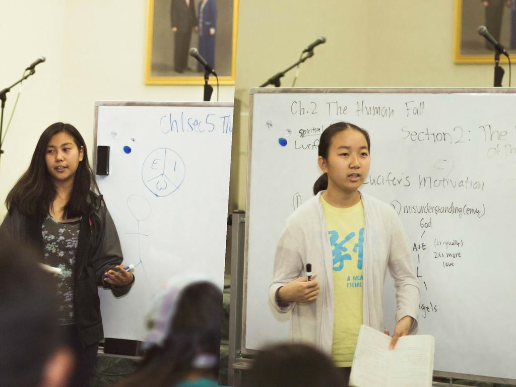 (L to R) Naomi Kotani and Kayun Hiraki learn how to share Unification Principles. 
