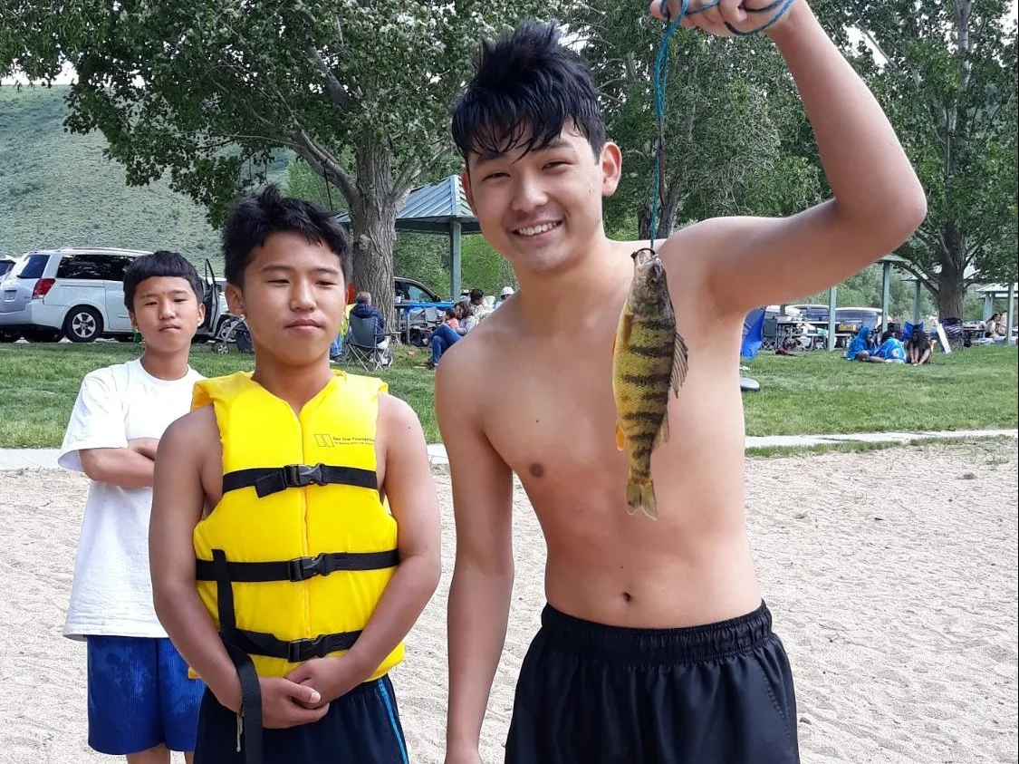 (L to R) Jin-won, Jin-Hyung, & Masao smile after catching a fish at Deer Creek Reservoir.