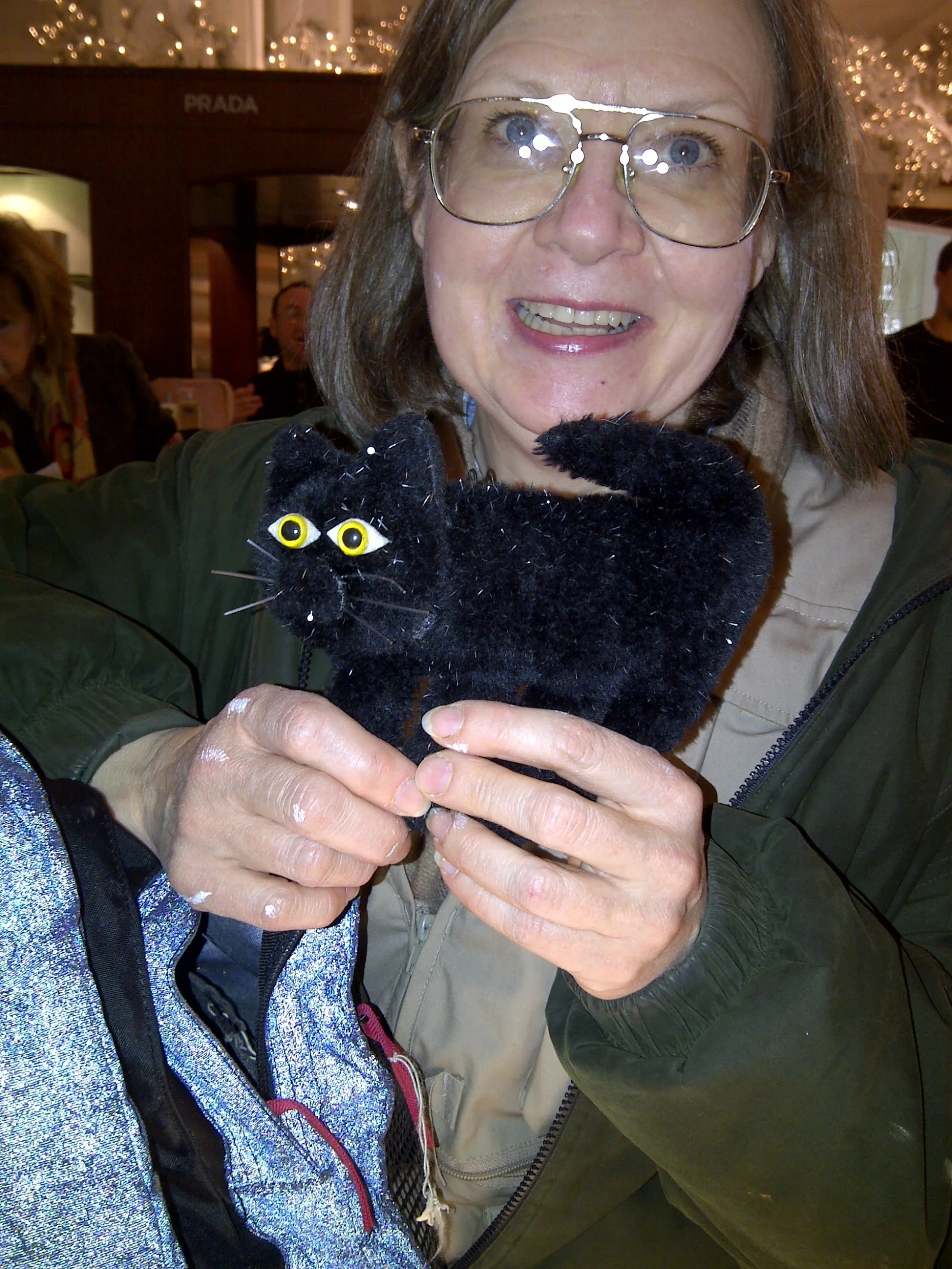 The artist, dried paint on hands, shows "Moxie" to a friend.