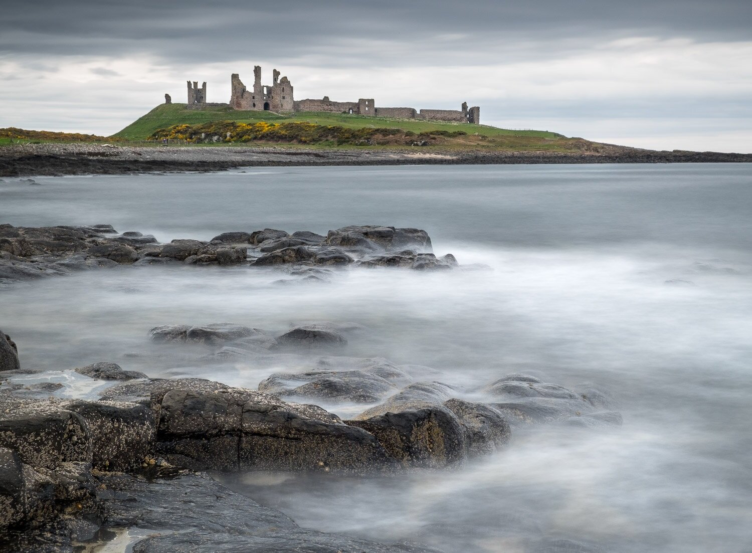 Dunstanburgh Castle ruin from Craster, Northumberland, England