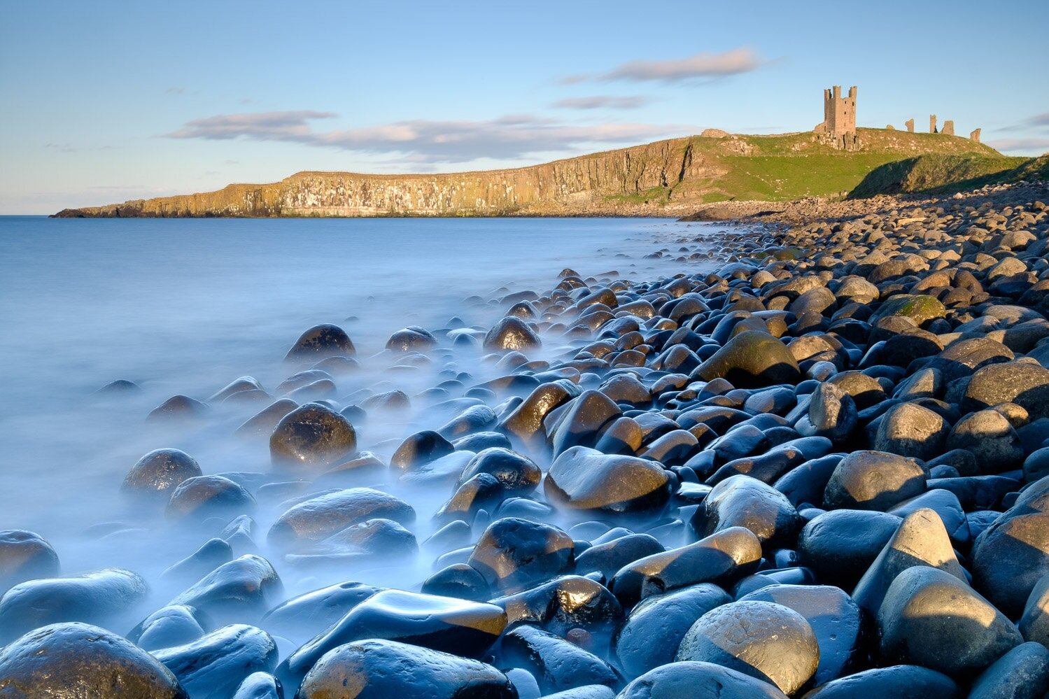 Dunstanburgh Castle ruin from Embleton Bay, Northumberland, England