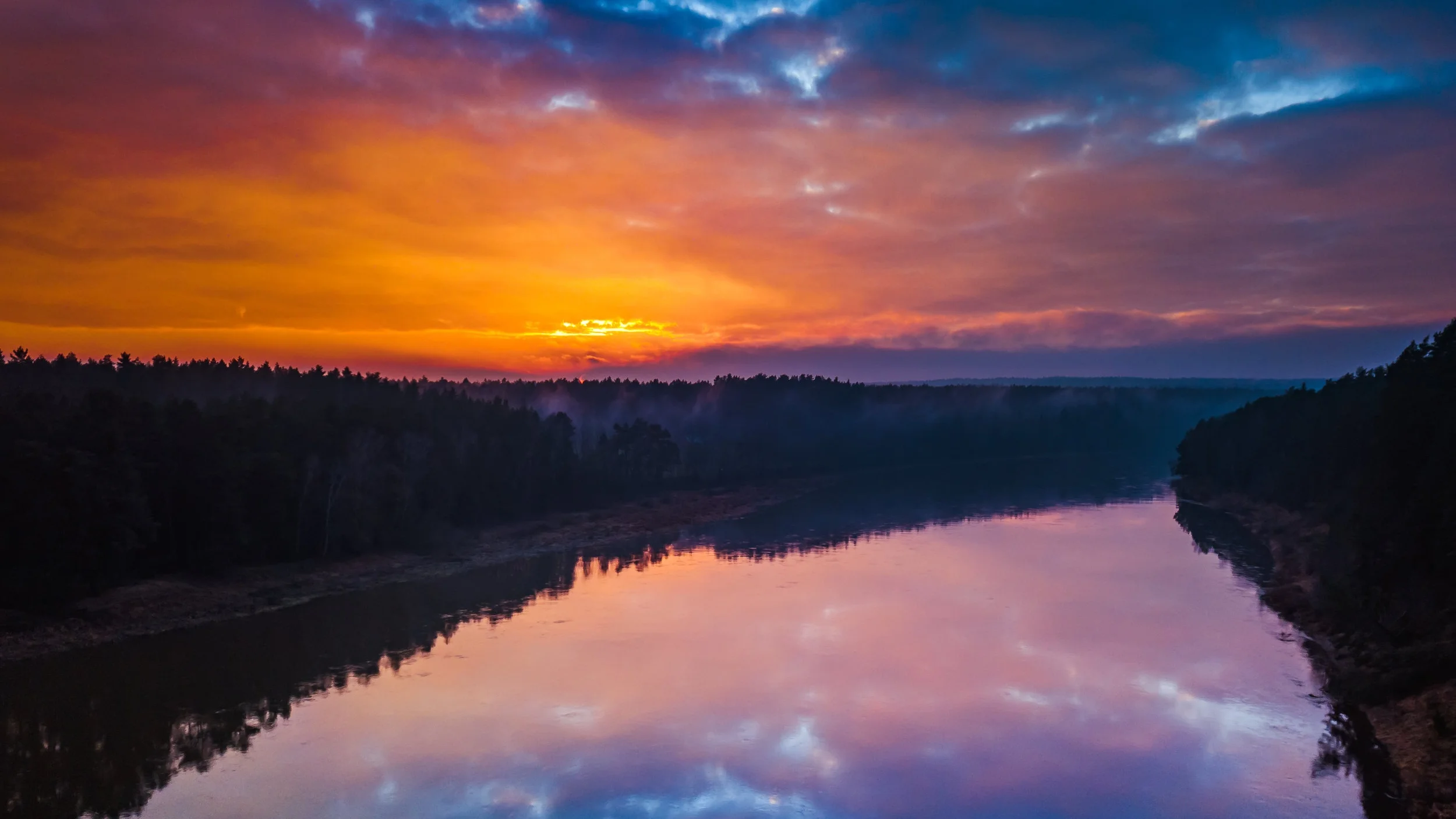 AdobeStock_187010487 Aerial sunrise or sunset with colorful sky and water rivr.jpeg