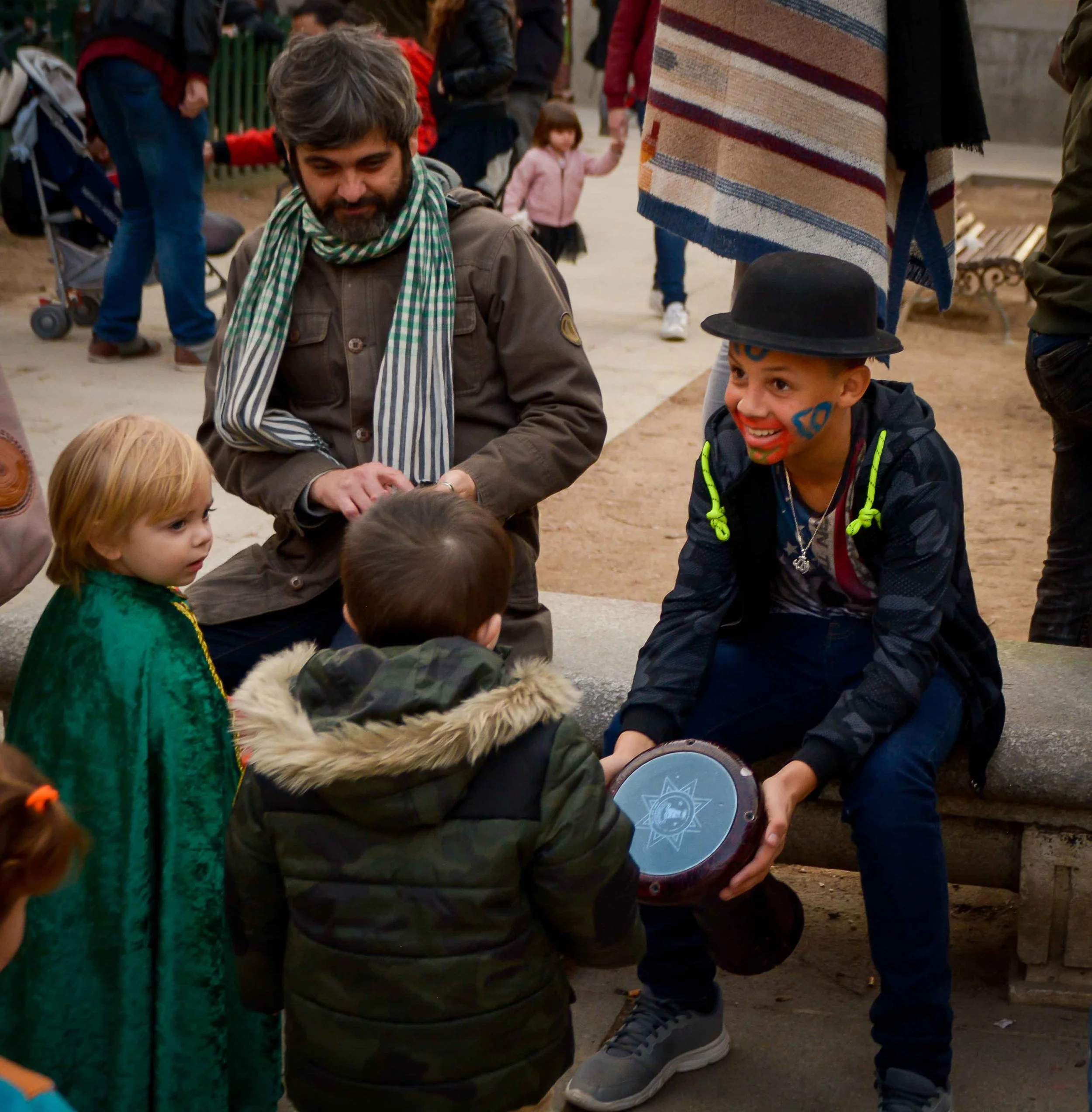 Children share a drum during a carnival celebration in Madrid.