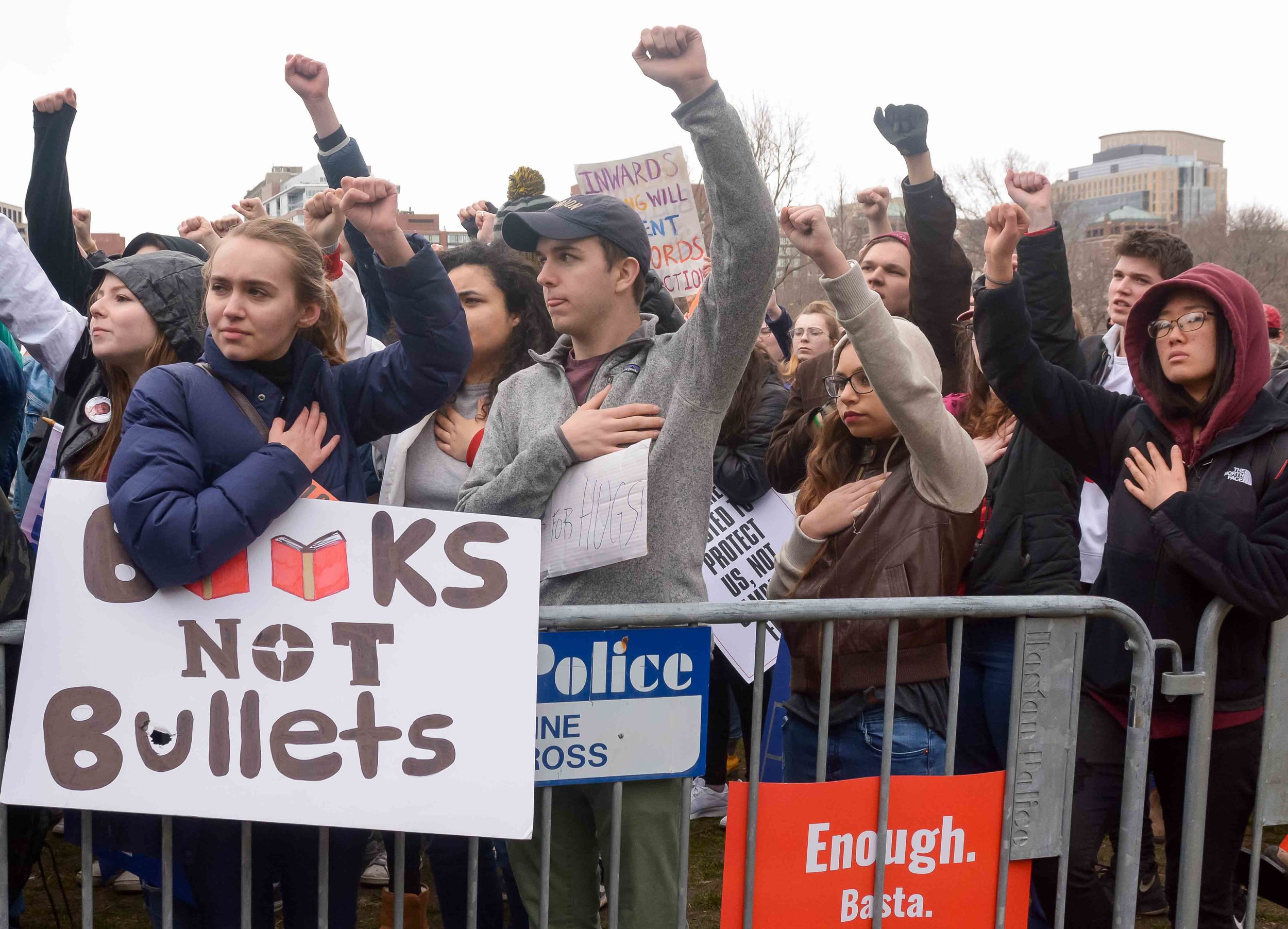 Sydney Olney holds a sign stating "books not bullets" as students gather on Boston Common during the March for Our Lives protest.