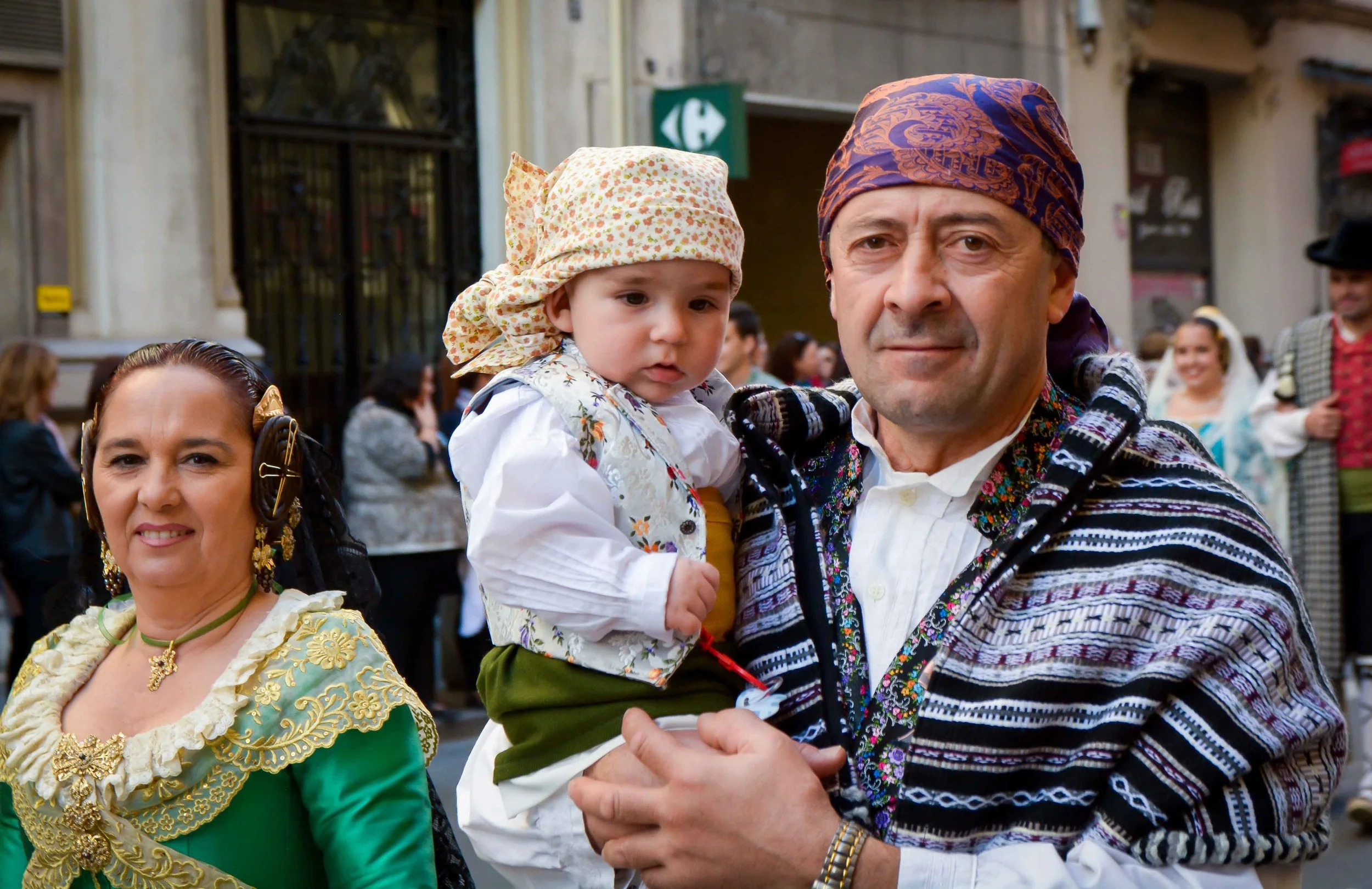 Participants in the Ofrenda de Flores, a part of the festival of Las Fallas in Valencia, Spain, walk toward the Plaza de la Virgin to deliver an offering of carnations, March 17.