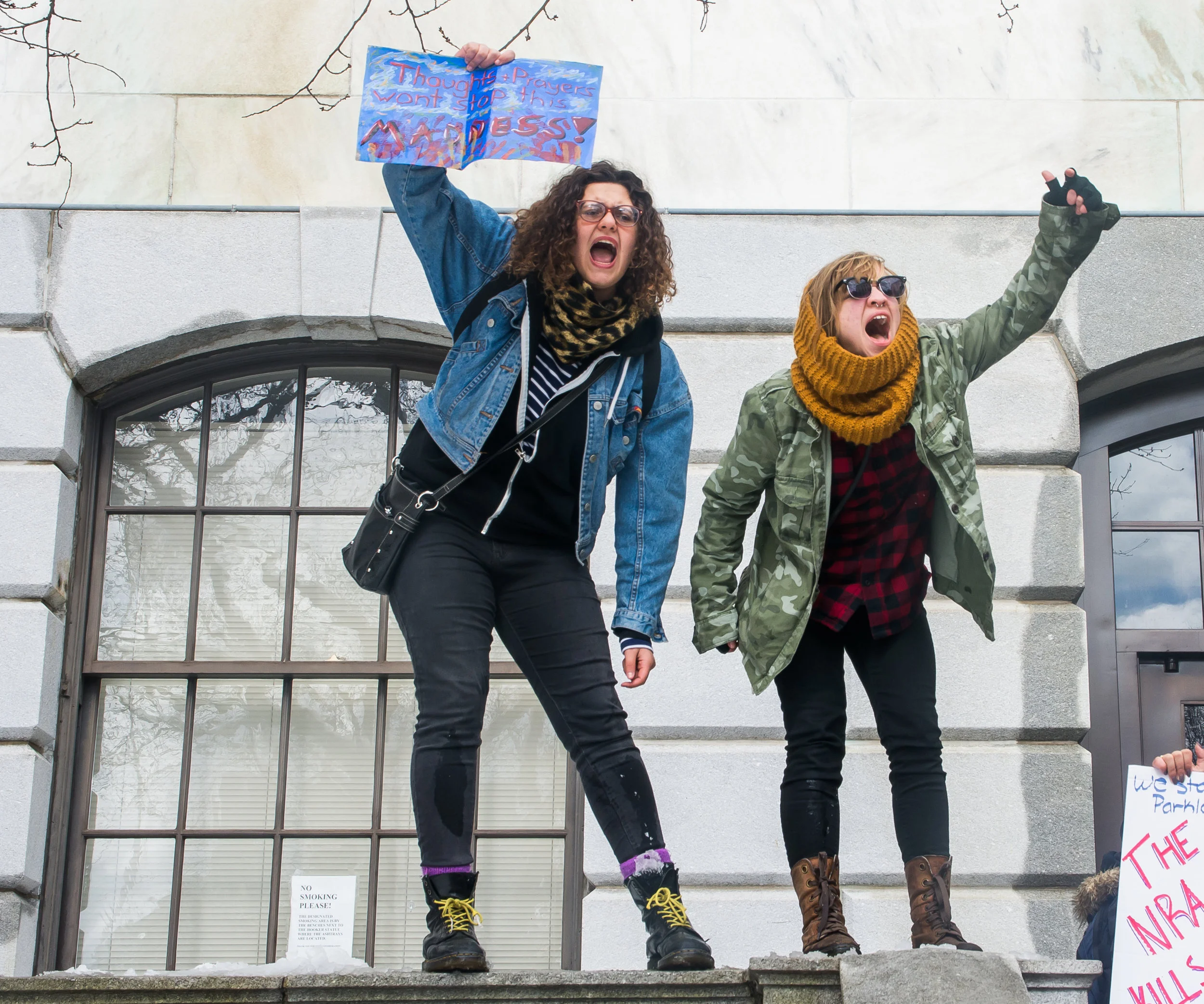 Jennifer Lima and Ava Quadros cheer as protestors gather outside the Massachusetts State House during the Walkout for Action on March 14.