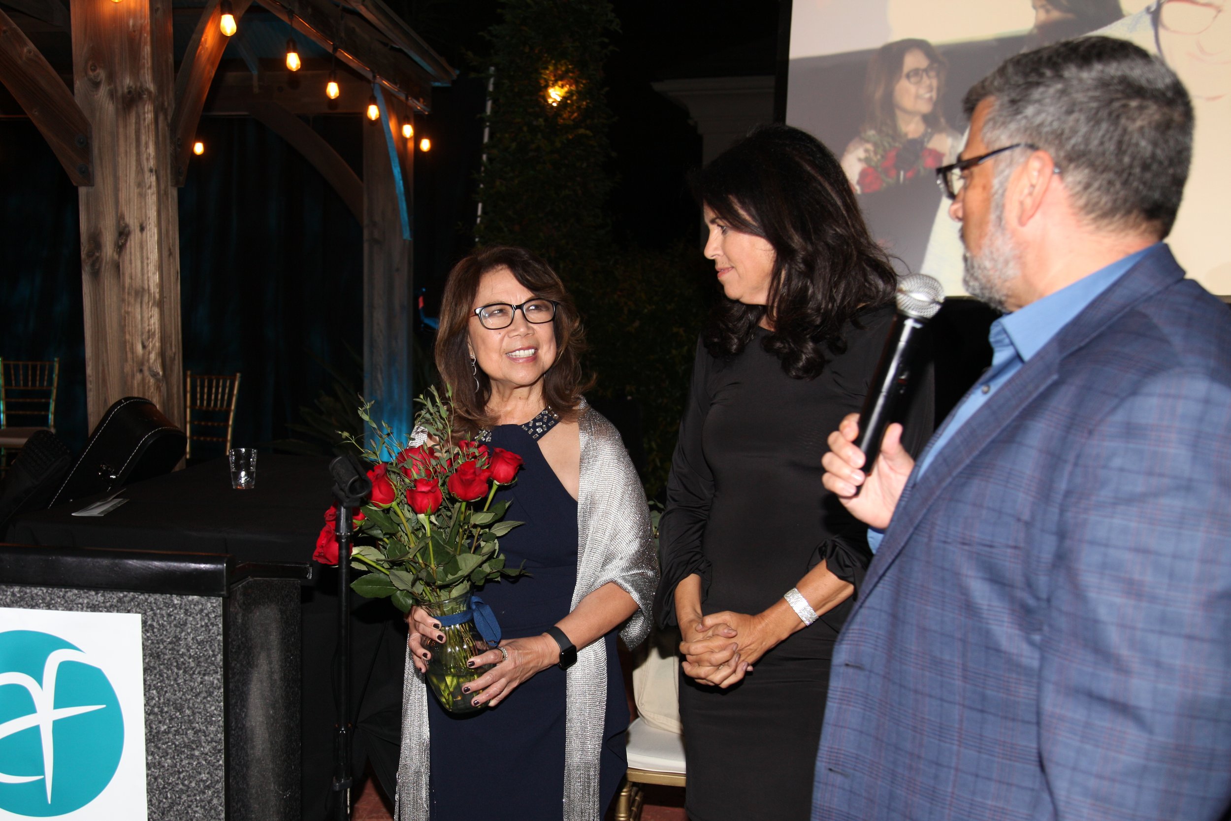 Dr. Erlinda Gordon with emcees Sara Welch and Honorable Marc Aveni