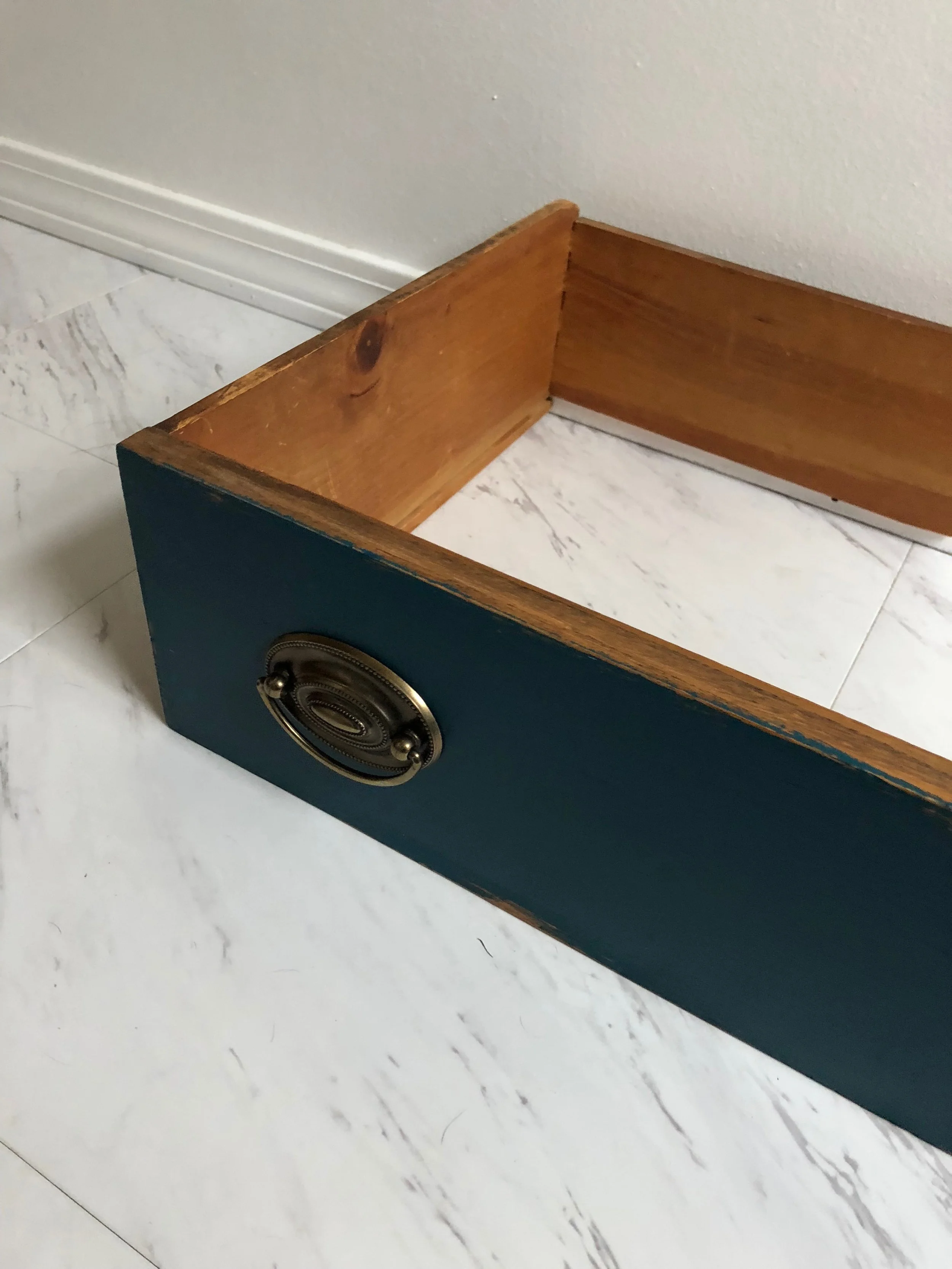 The top drawer after removing the bottom panel. I put the back of the back of the drawer back into place for stability while I let the glue dry around the joints. It was later removed