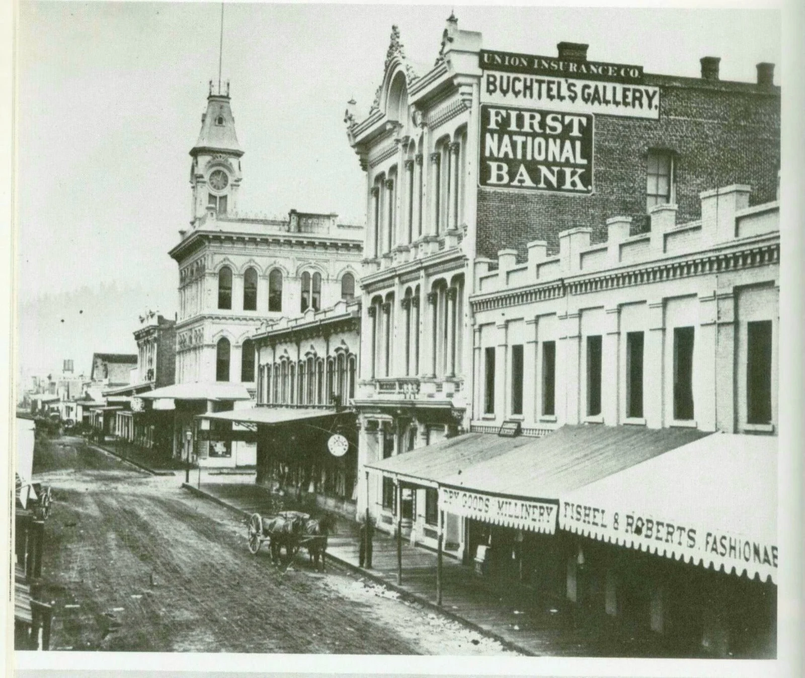 First Street before the fires of 1872 and 1873. Note the Buchtel Gallery where Simeon Small was allowed to use the darkroom in the aftermath of the fire. Courtesy Cafe Unknown .