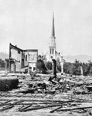 The photographer of this scene of the fire's aftermath is unknown. In Burying My Dead , I attribute it to Simeon Small. Courtesy Oregon History Project.
