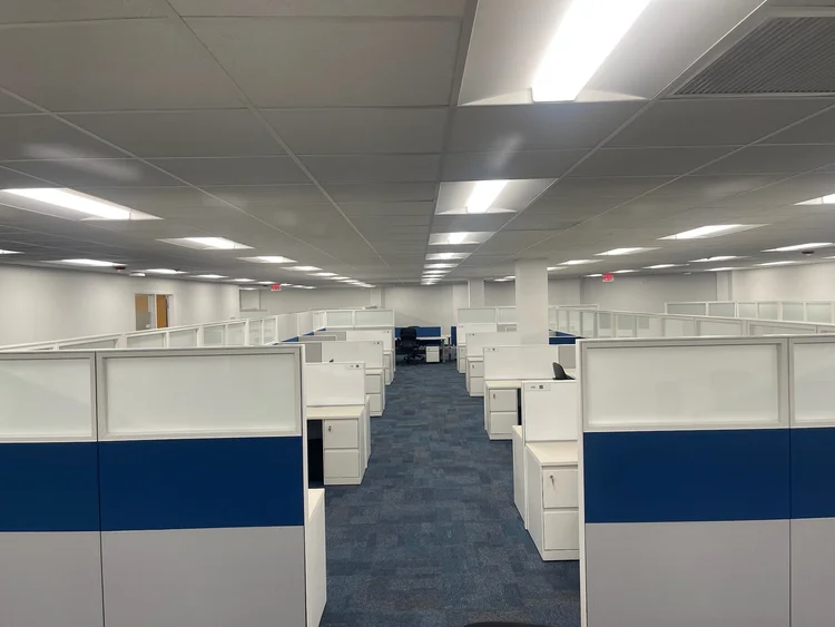 Office floor with a new 2x2 acoustical ceiling grid and lay-in lights