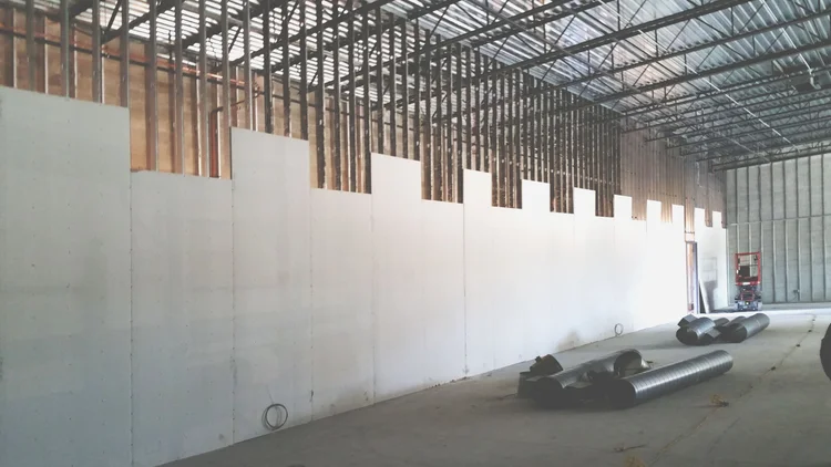 Drywall hung on a long retail wall