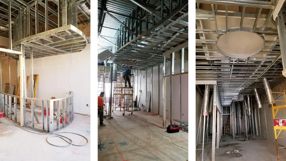 Crew member framing walls on a build-out