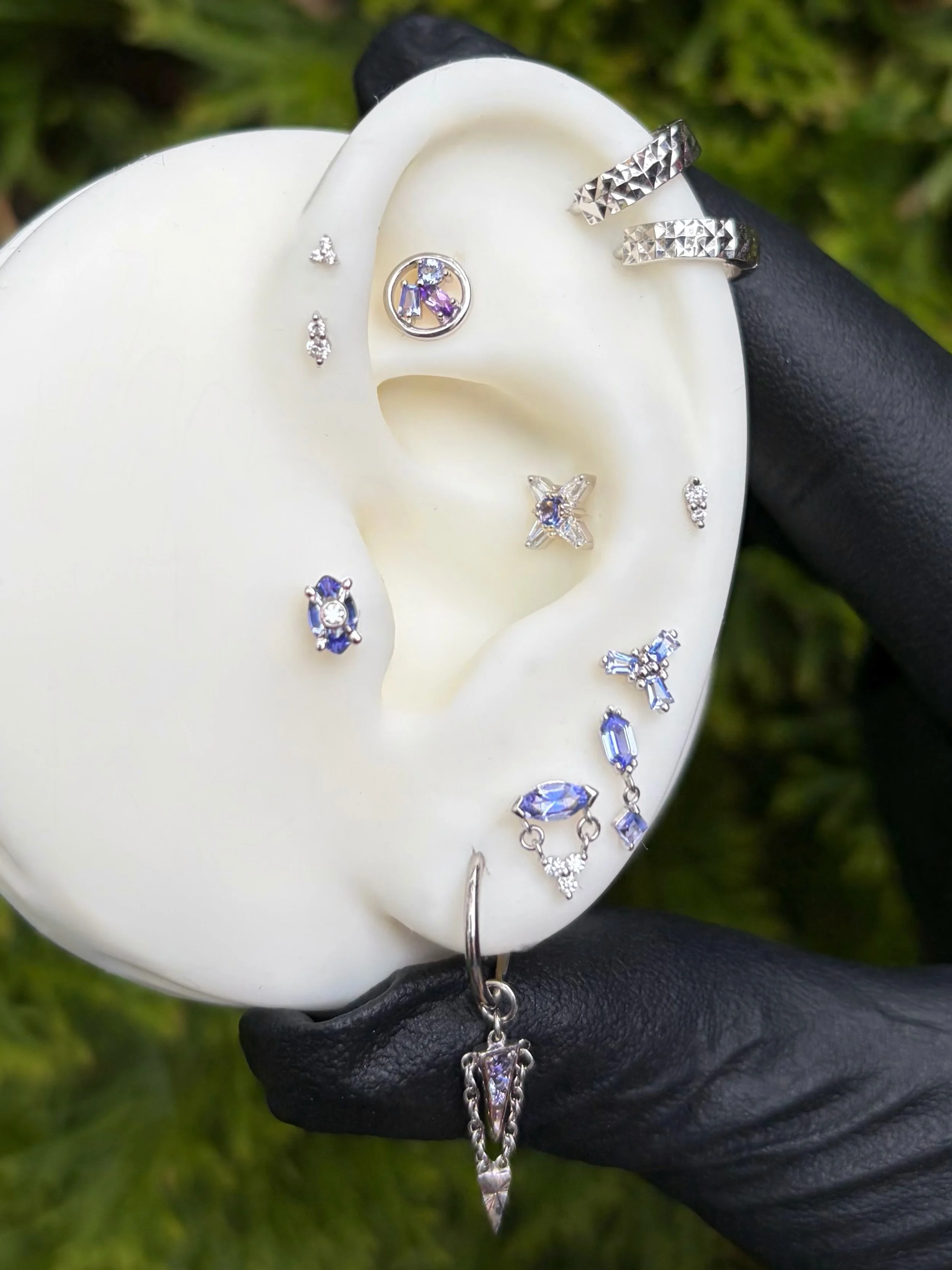 Icy white gold has made a mega comeback - especially with pops of purple. This curated set from @chloed______ uses a slew of new pieces to the studio from our wonderful friends at @emberbodyjewelry ✨