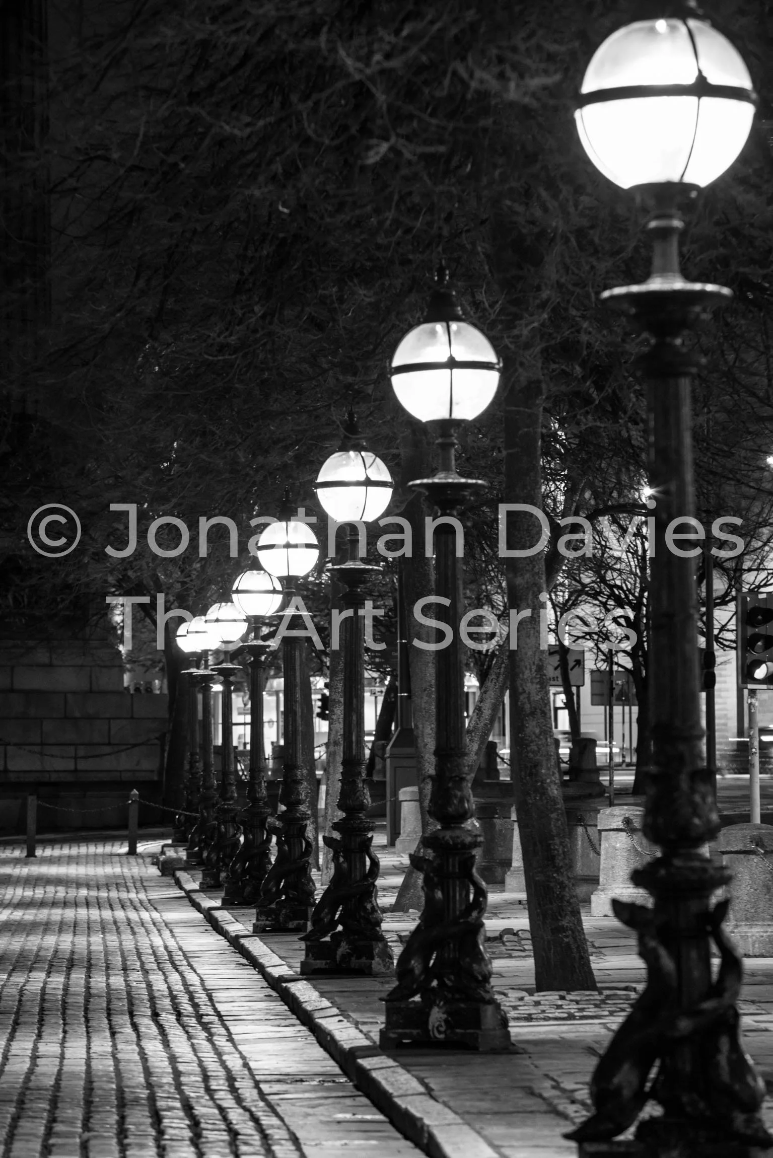 Victorian streetlamps light the cobbled street
