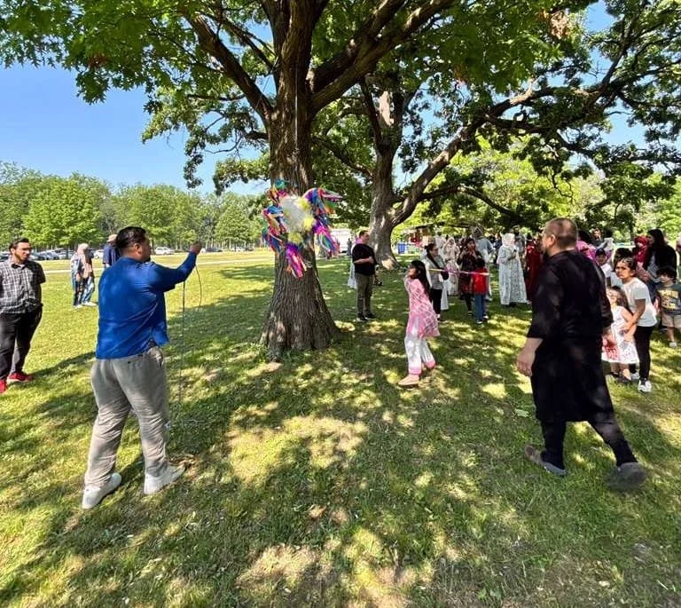 Community members take turns at a piñata during Ojala's Eid celebration. | Provided by  Jordan Esparza-Kelley