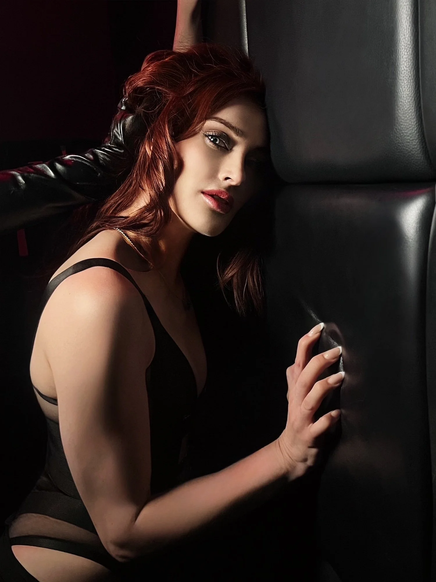 Mistress Dasha demonstrating CNC roleplay fantasy pressed up against a leather padded wall at Chicago Illusions Dungeon and held in place by a dominant wearing a black leather glove