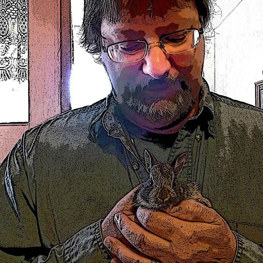 This is Steve with a baby bunny. Yes, this is a shameless ploy (Steve, tenderly holding a baby bunny, he would be a good person to do your editing or design dontcha think?). The bunny was released unharmed back into the yard after the photo was taken.