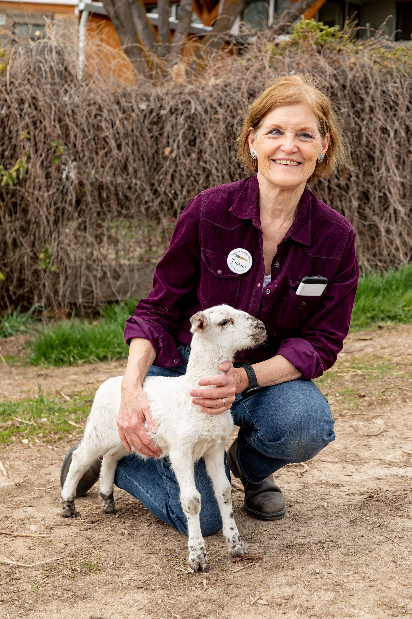 Tamara poses with the lamb, Nibbles.