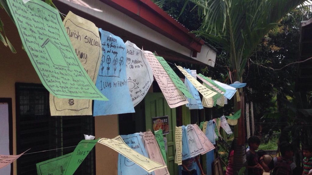   At the start of the New Year, certain Buddhist monks hang new prayer flags to spread positive energy over the land via the wind. Students made their own wishes for their families and communities on these simple flags–an homage to the beautiful flag