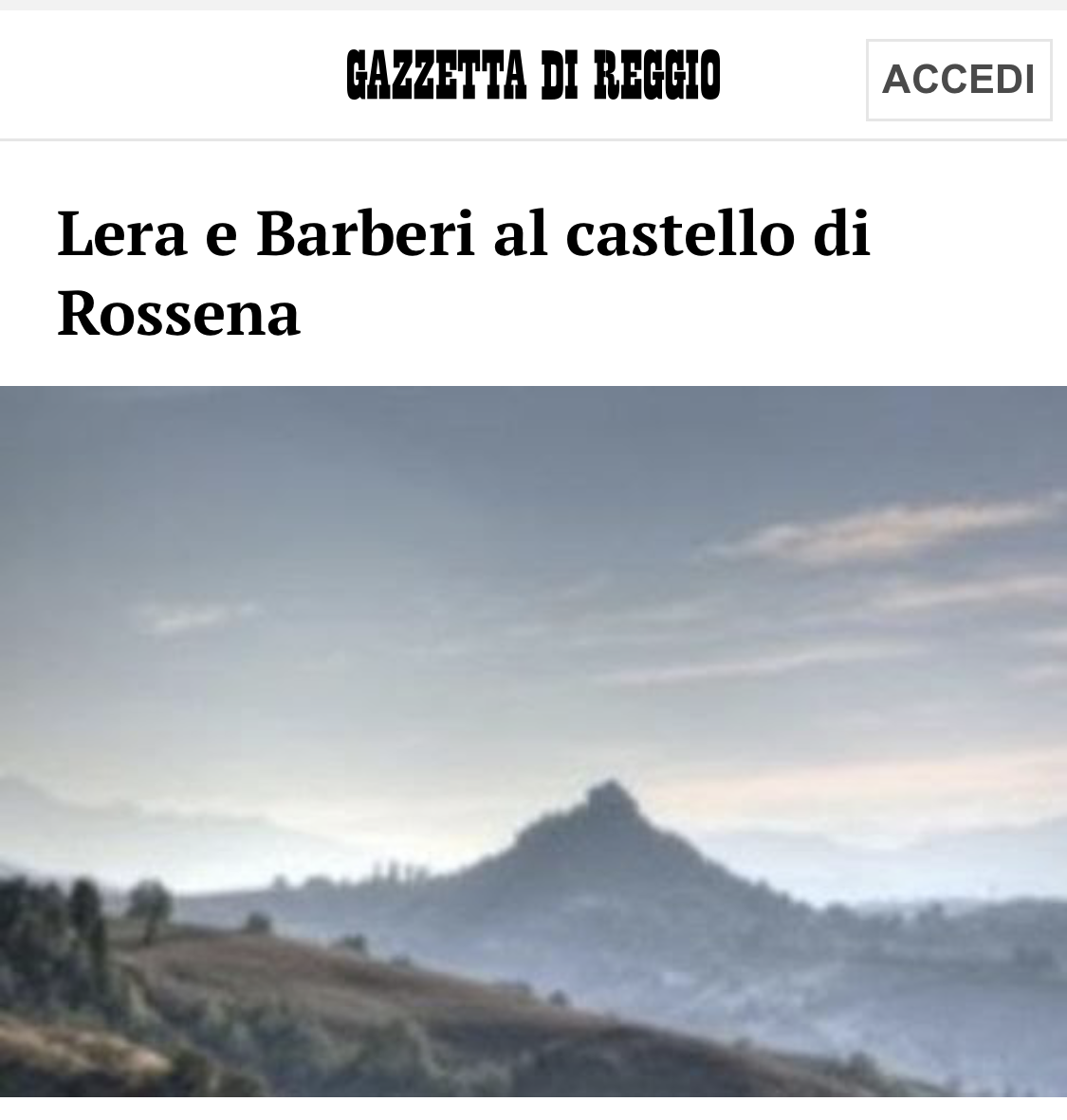 Cover page of Gazzetta di Reggio newspaper with a landscape photo of mountains and a castle silhouette.