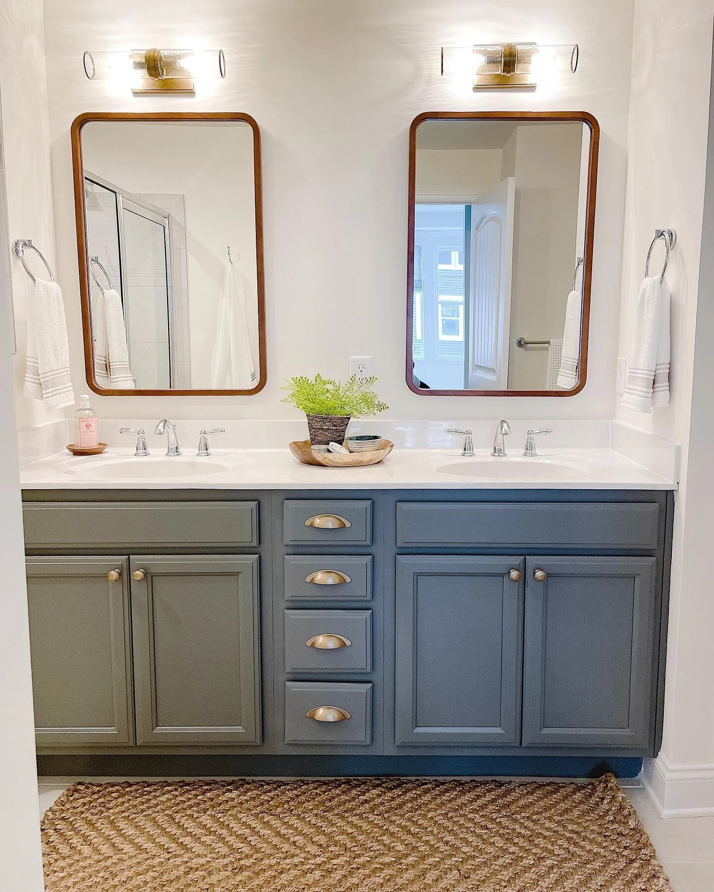 Upgrading builder grade mirrors and light fixtures is one of the best and most cost effective ways to elevate your space! Swipe left to see the old fixtures. We asked our builder to not even install the single large mirror as we knew we wanted double