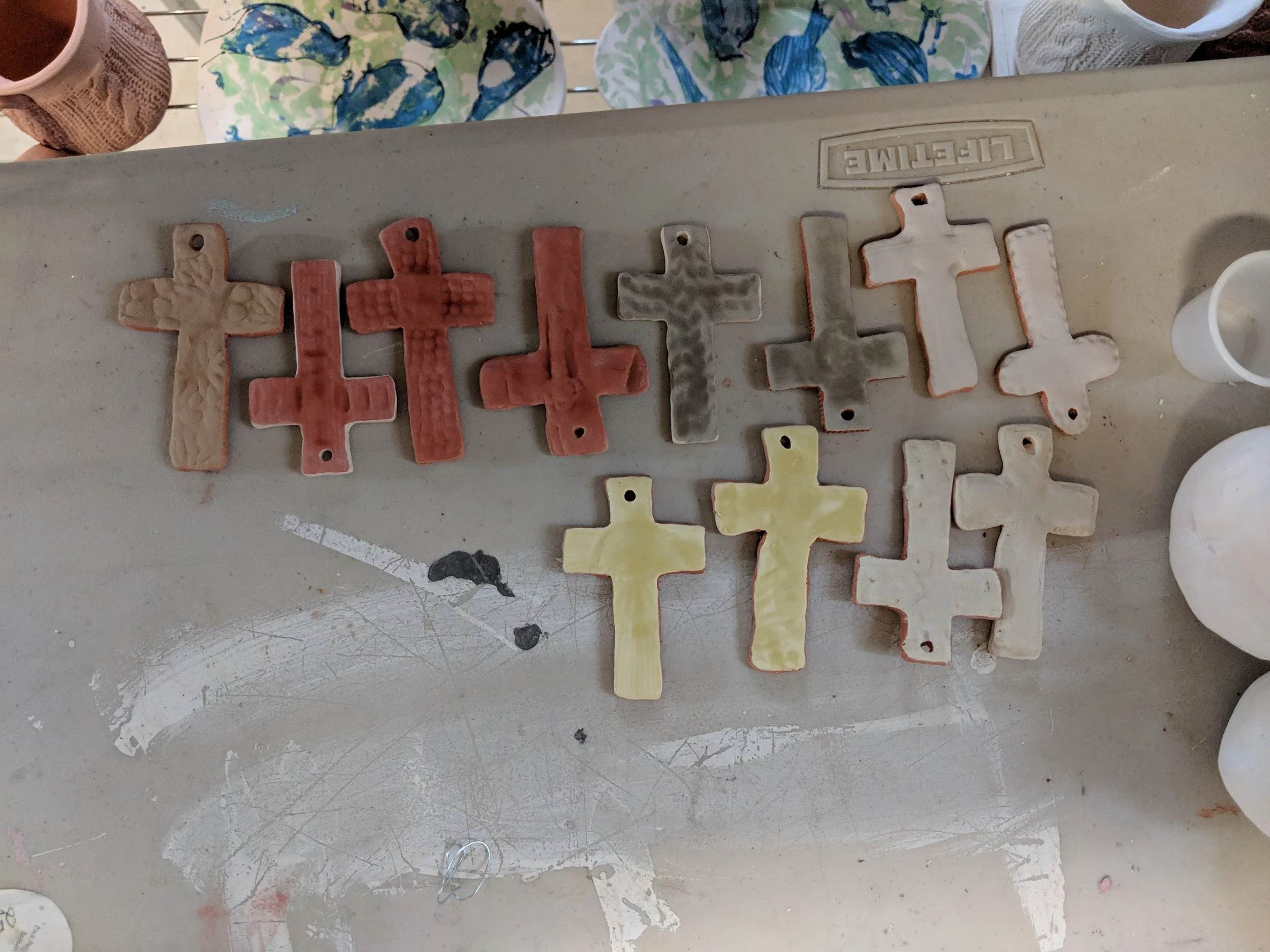 Crosses glazed and ready for the final firing at Back Porch Pottery’s kiln.