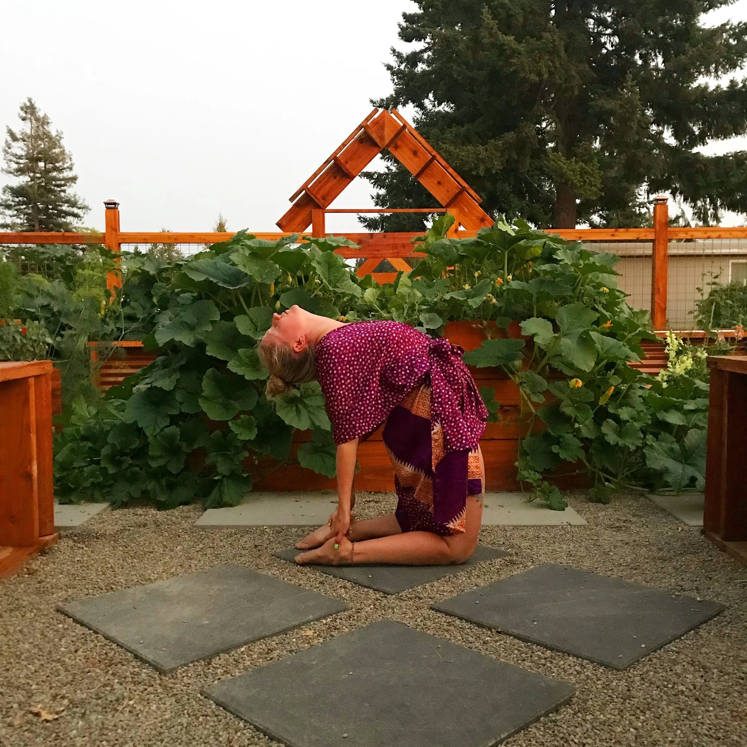 Brit practicing yoga inside the BZen Wellness garden.