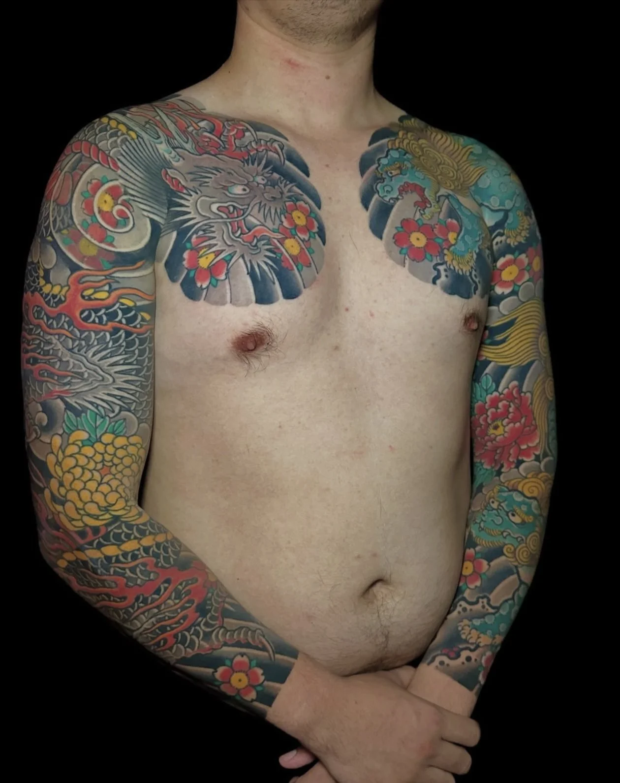 Japanese arm sleeve tattoo with dragon and fu dog