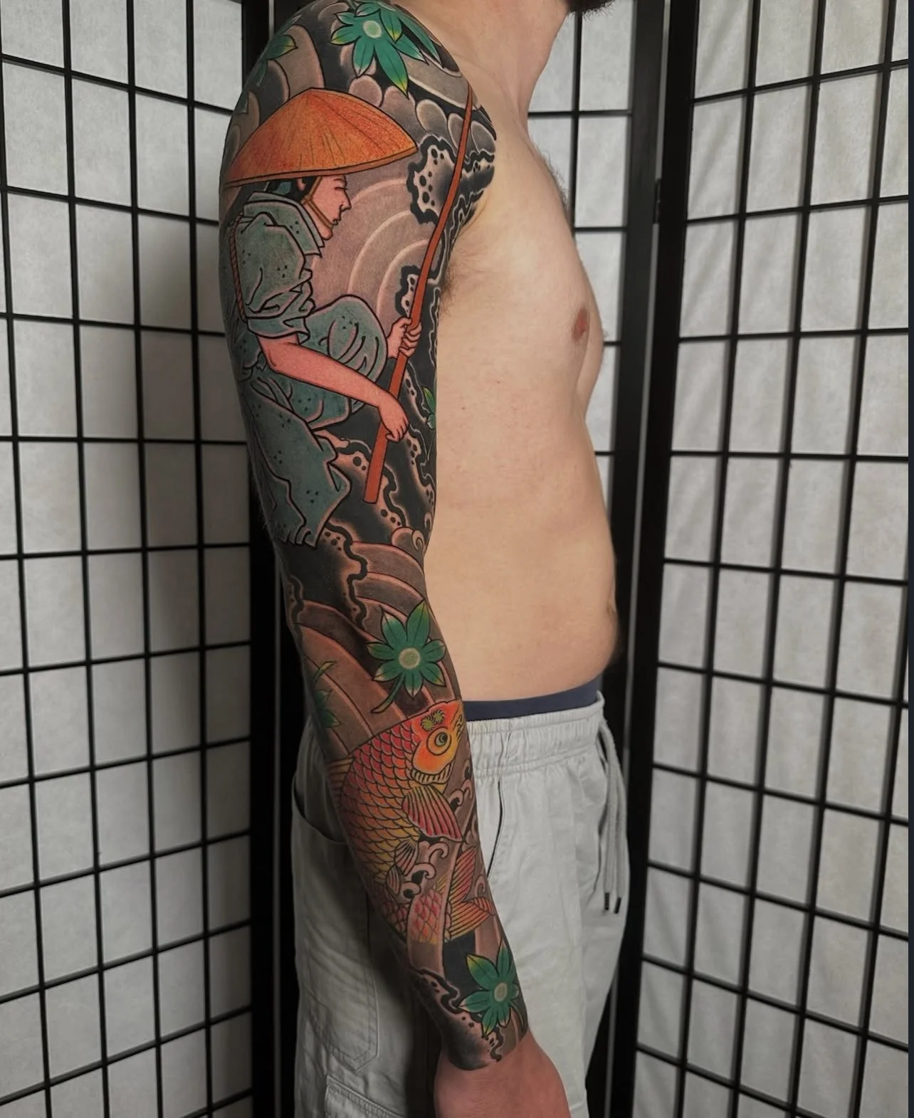 Japanese arm sleeve tattoo with fisherman and koi
