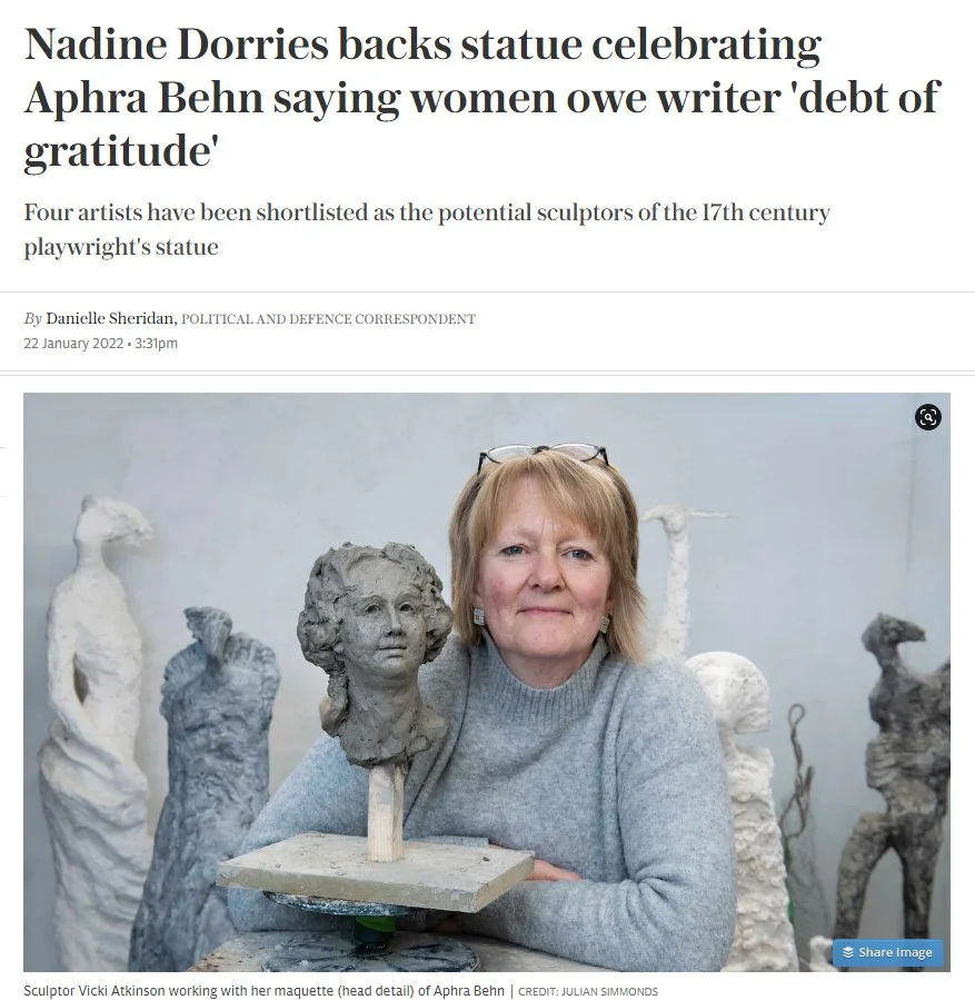 A woman sitting with several stone sculptures of female figures and busts, working on a sculpture of Aphra Behn's head in a studio.