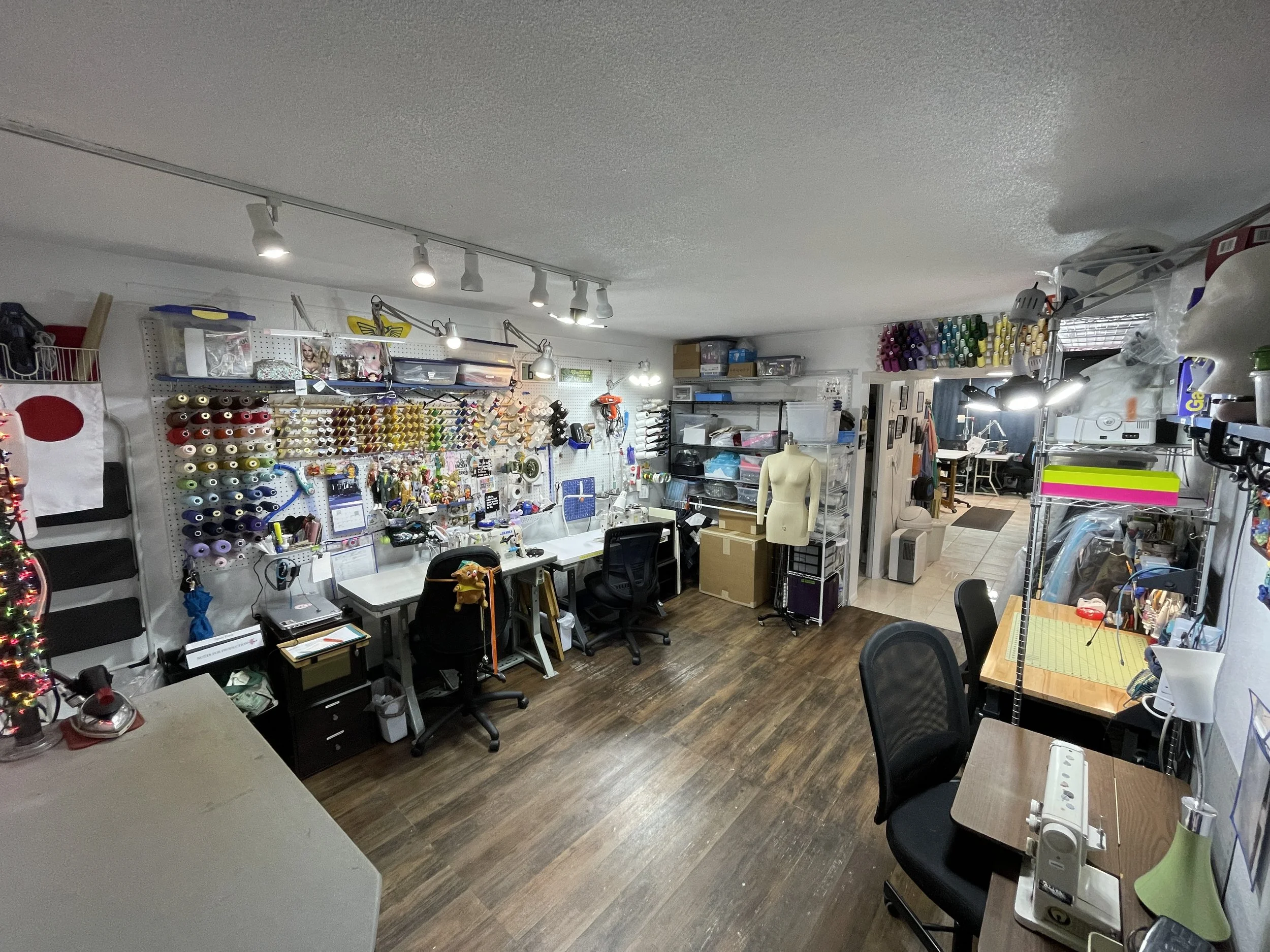 Interior view of a work space showing industrial machines and other sewing tools.
