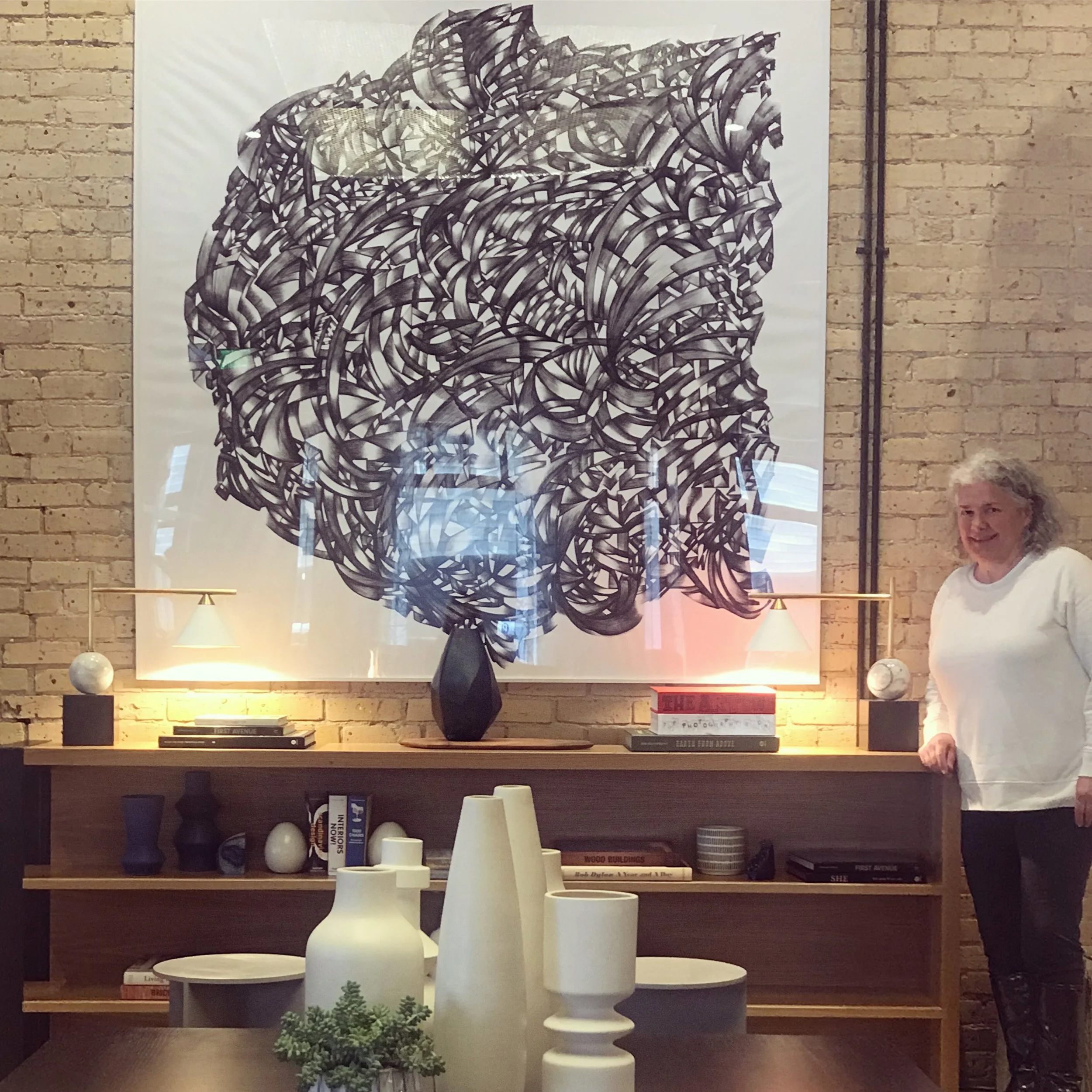 Gretchen in front of her 6’ print of one of her line drawings at the new Canopy By Hilton Mill District in Minneapolis