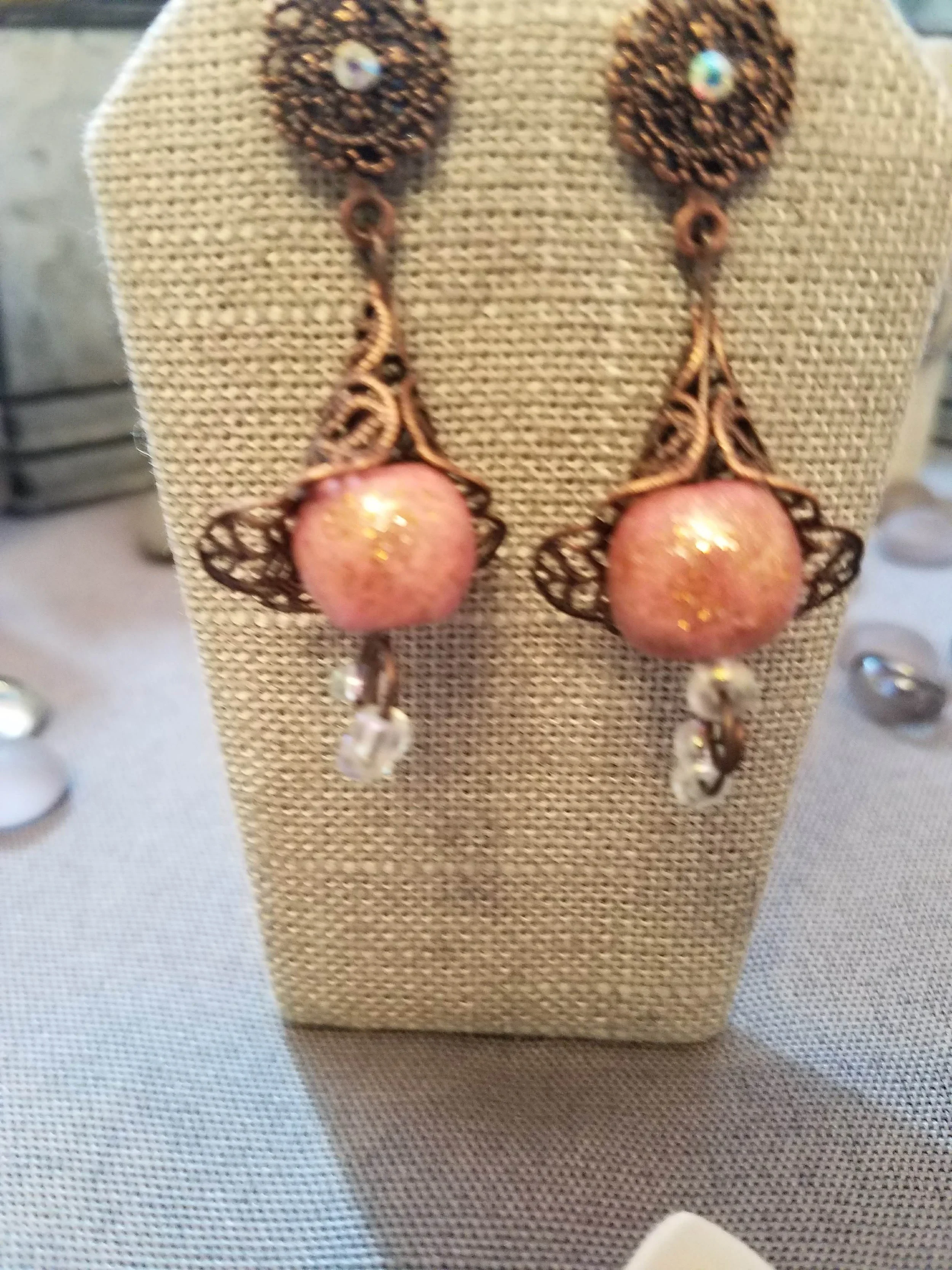 Antique copper filigree flower bell with pink polymer clay bead and iridescent glass beads