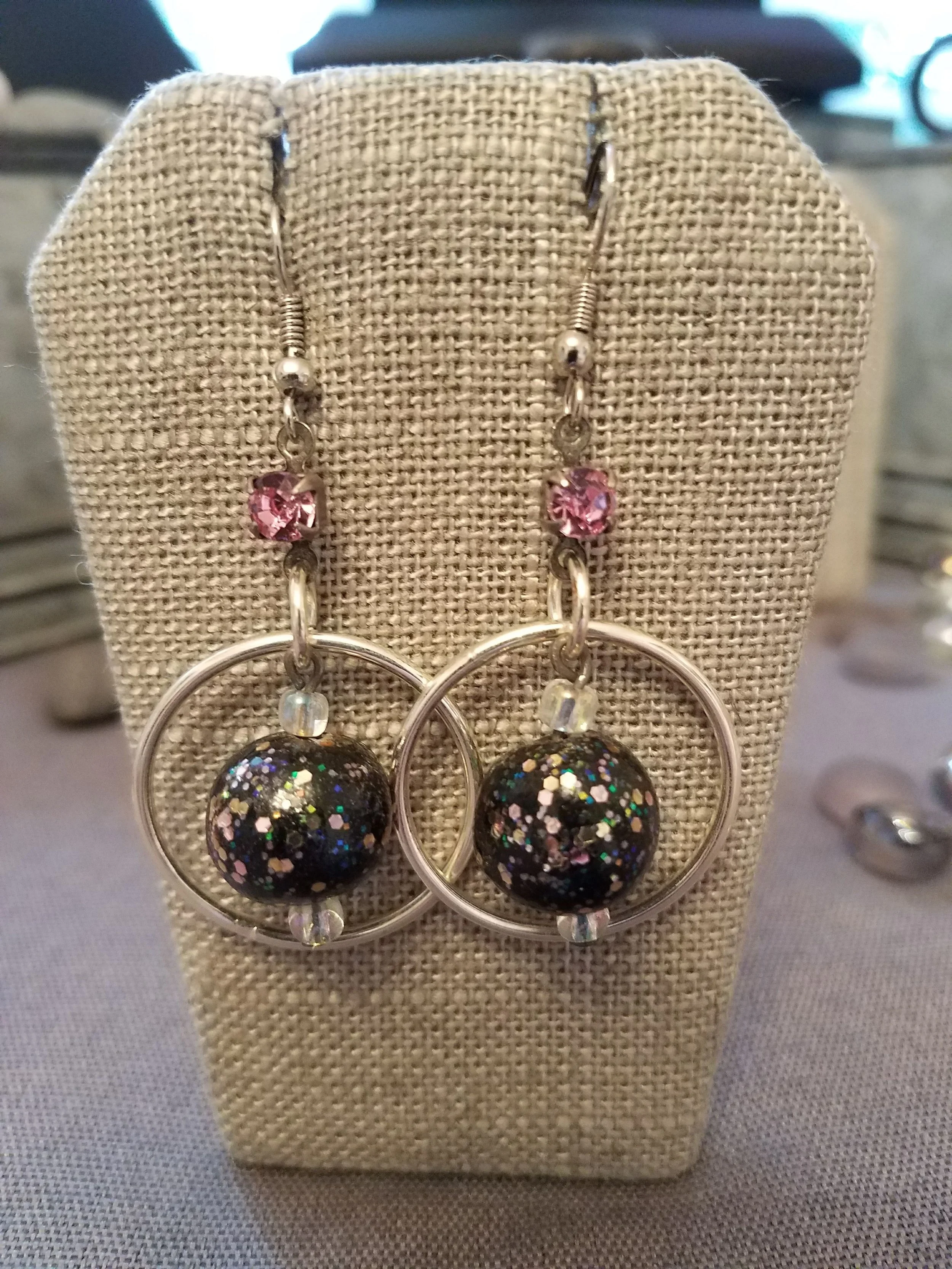 Black sparkle polymer clay bead with pink crystal