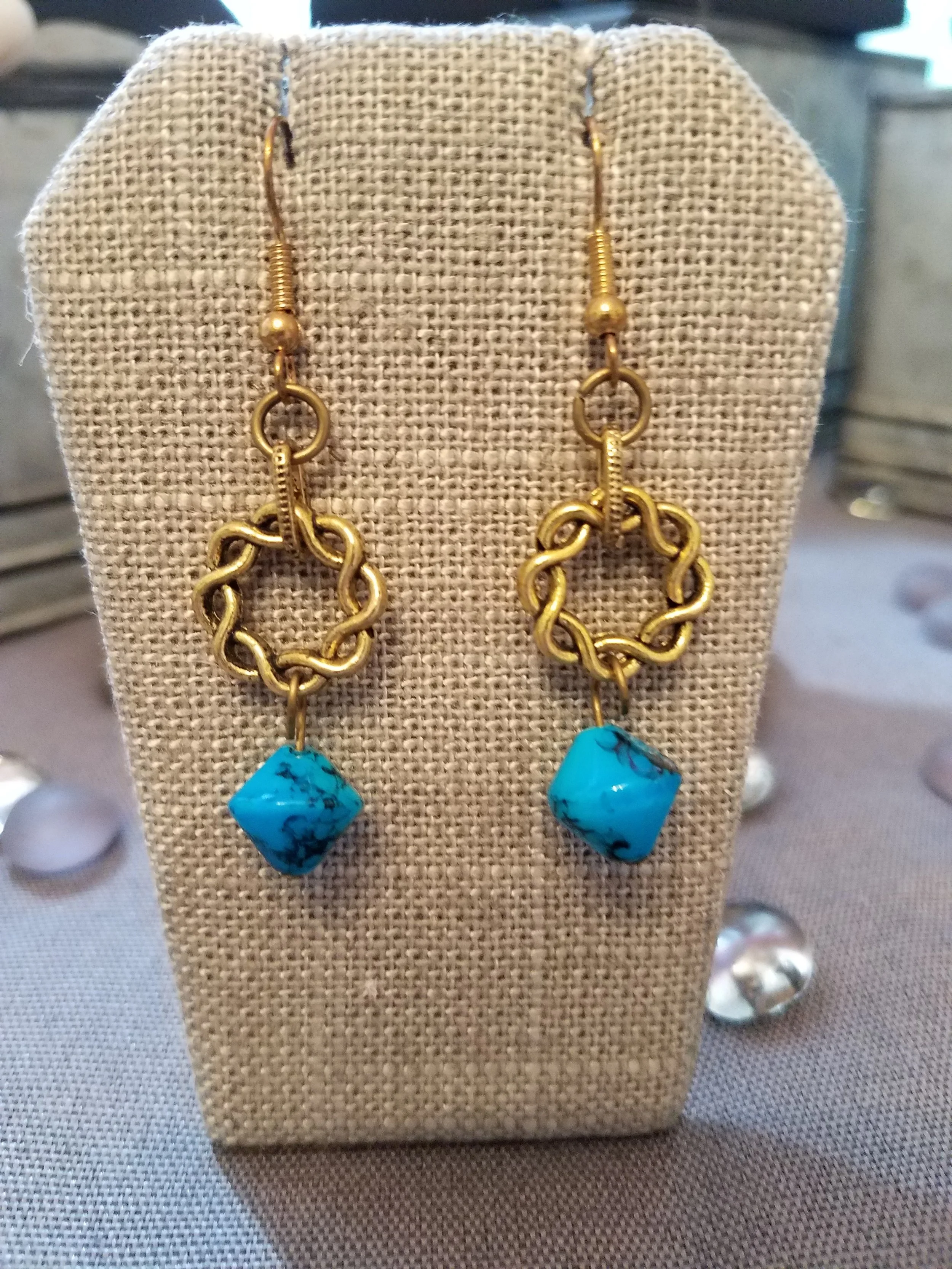 Gold braided wreath and turquoise bead