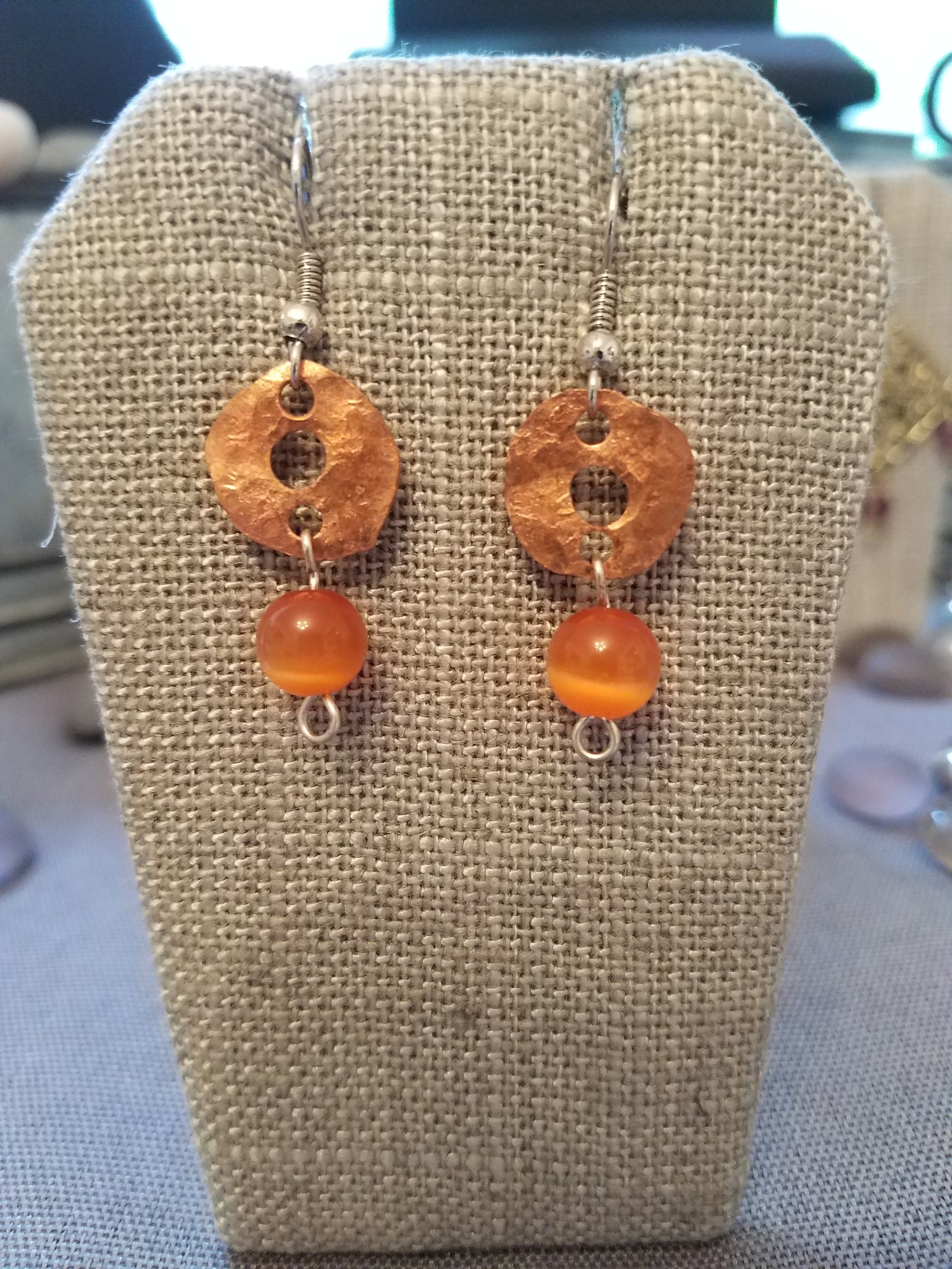 Copper washer with orange cats eye bead