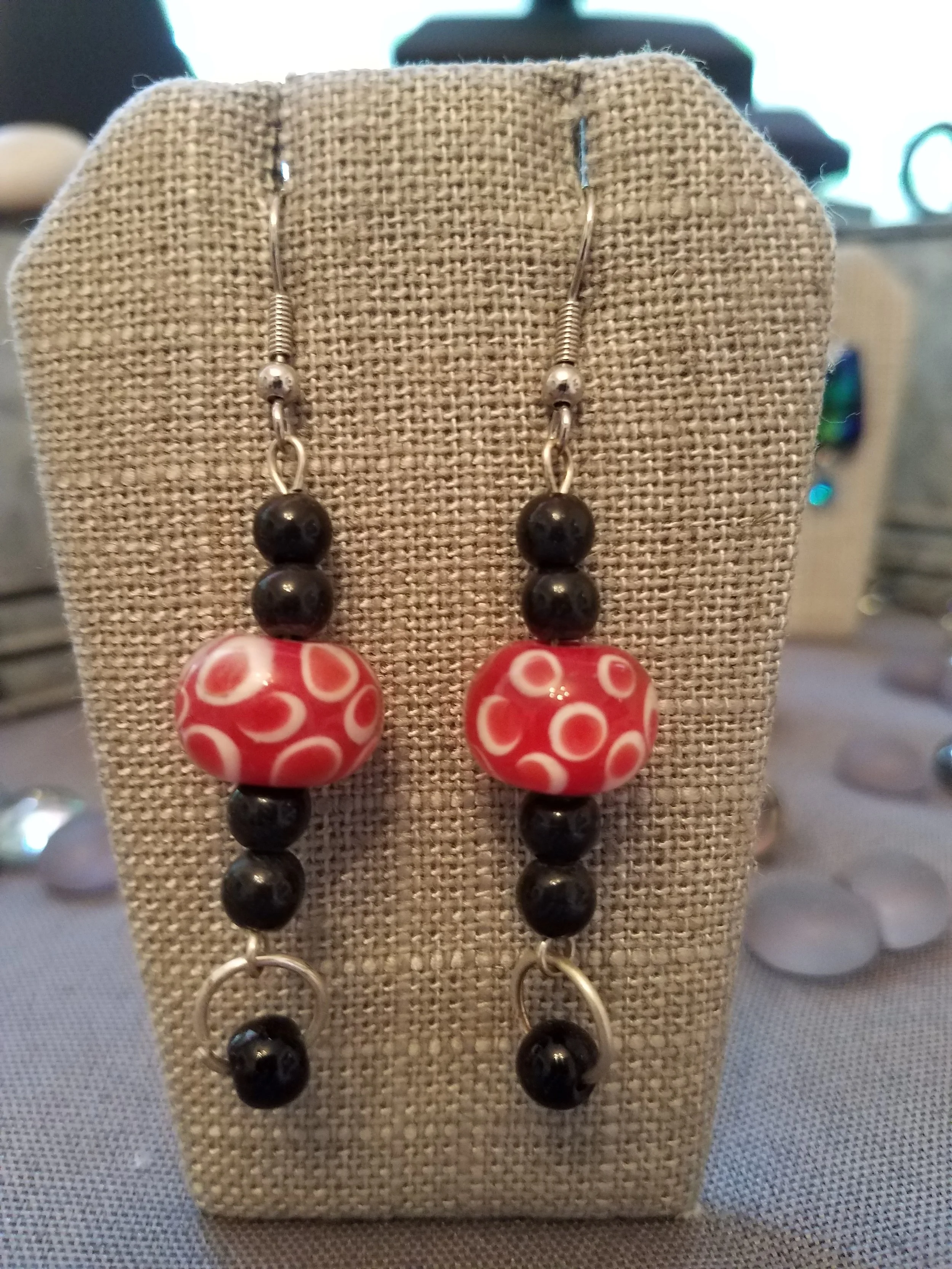 Red millefiori glass bead with black bead