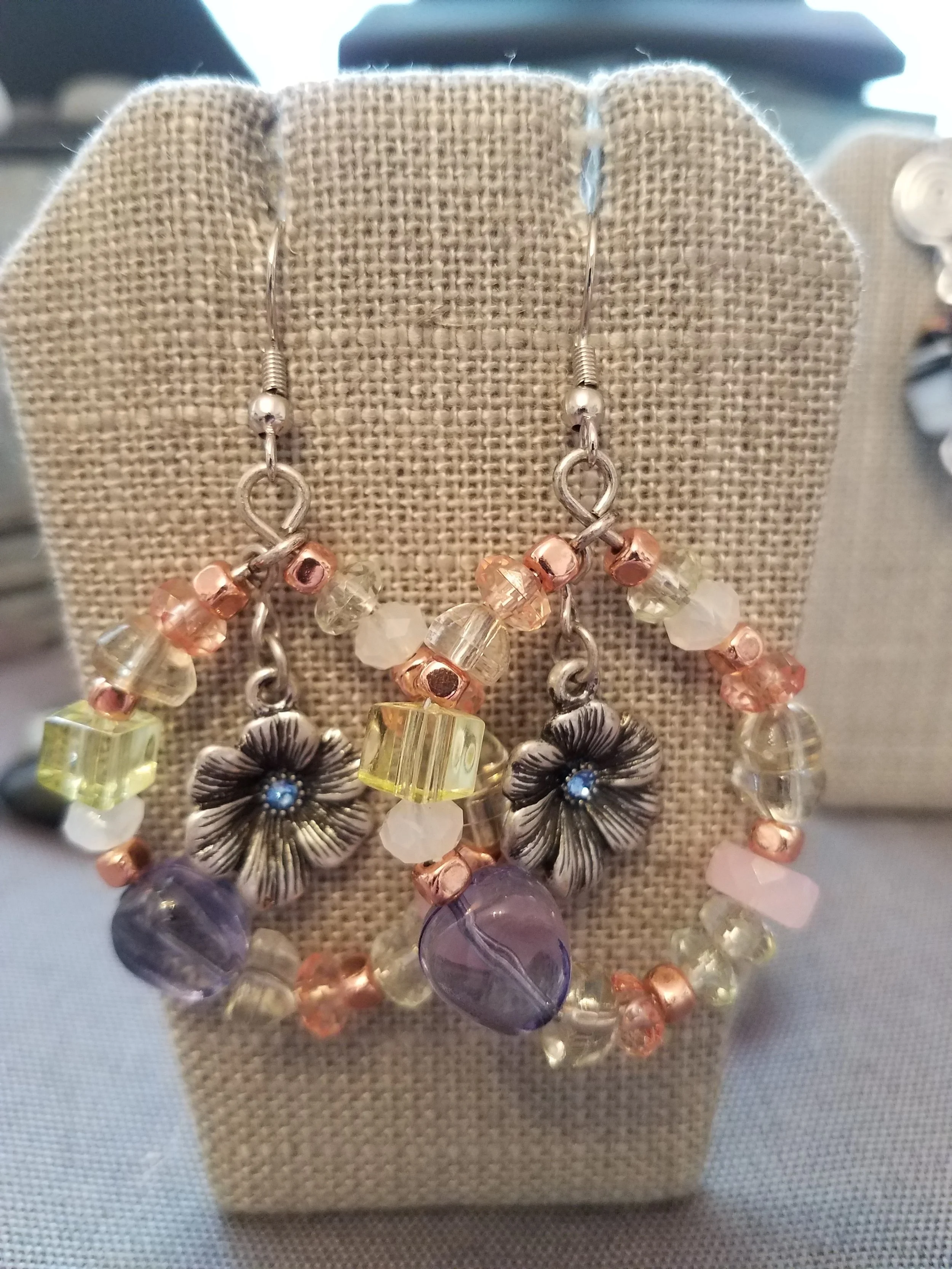Multicolored glass bead hoops with silver flower center and blue crystal