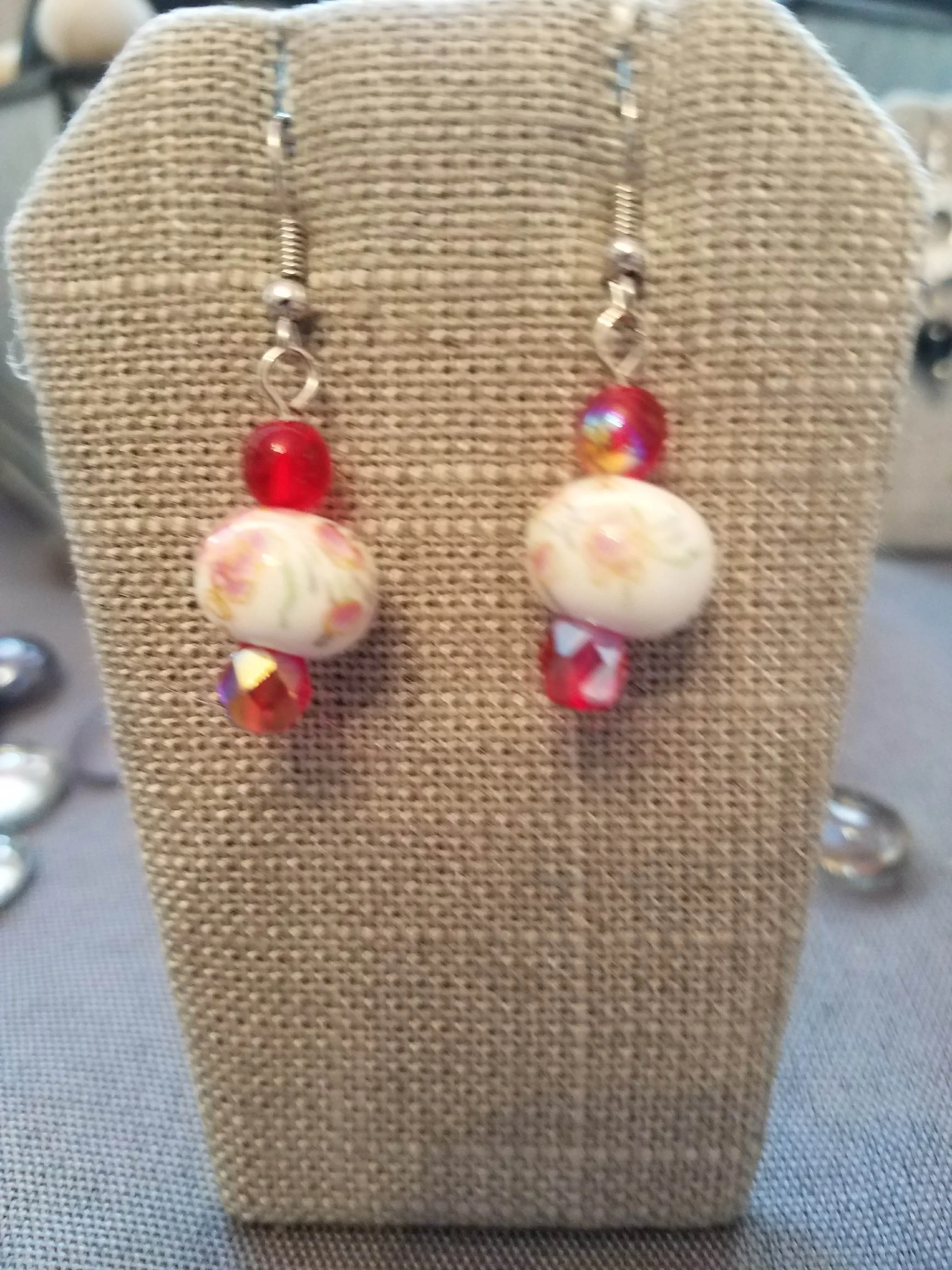 Floral ceramic bead with iridescent red beads