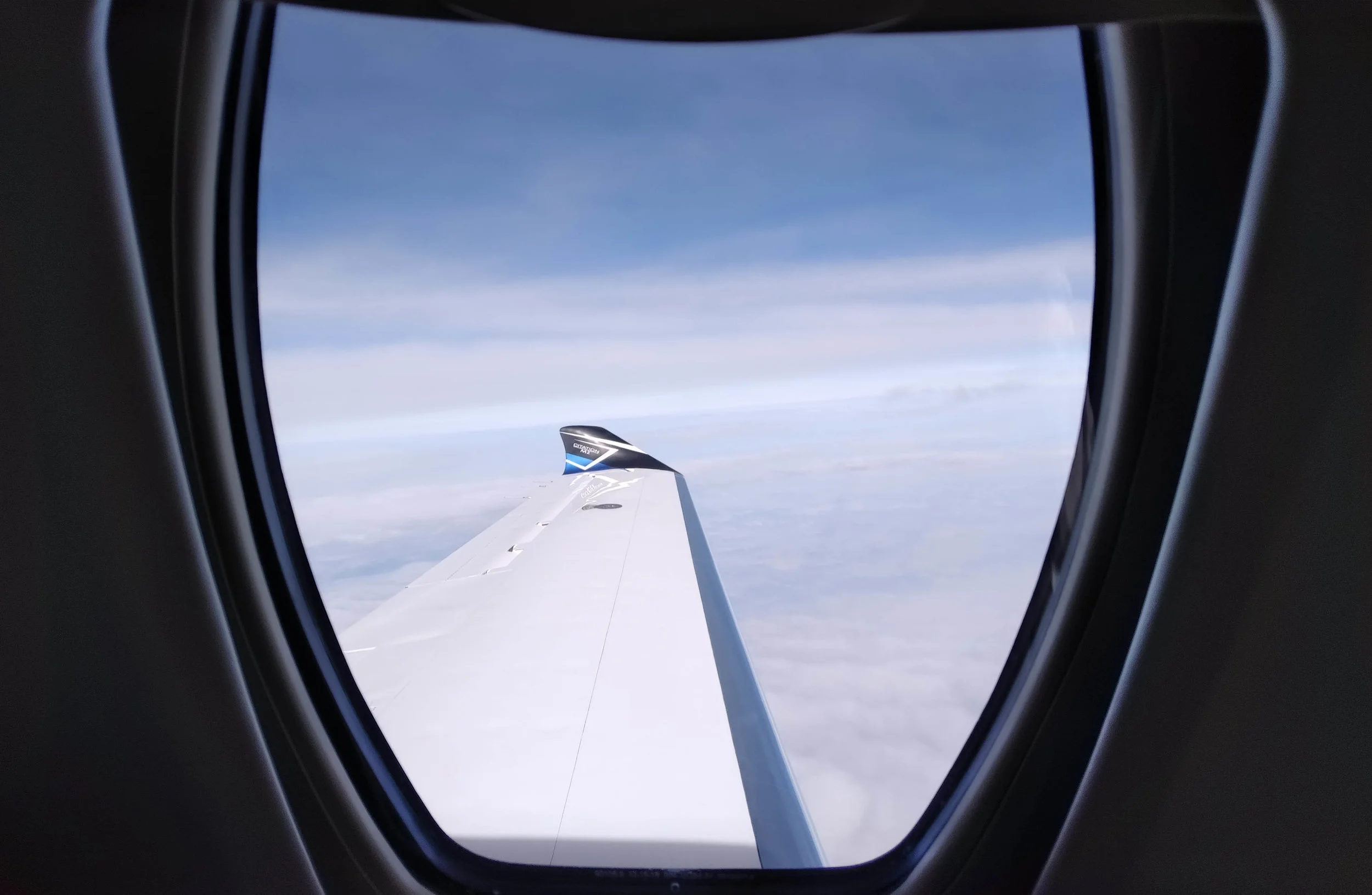 Looking out the uniquely-shaped Citation M2 window as we cruise comfortably above most commercial air traffic.