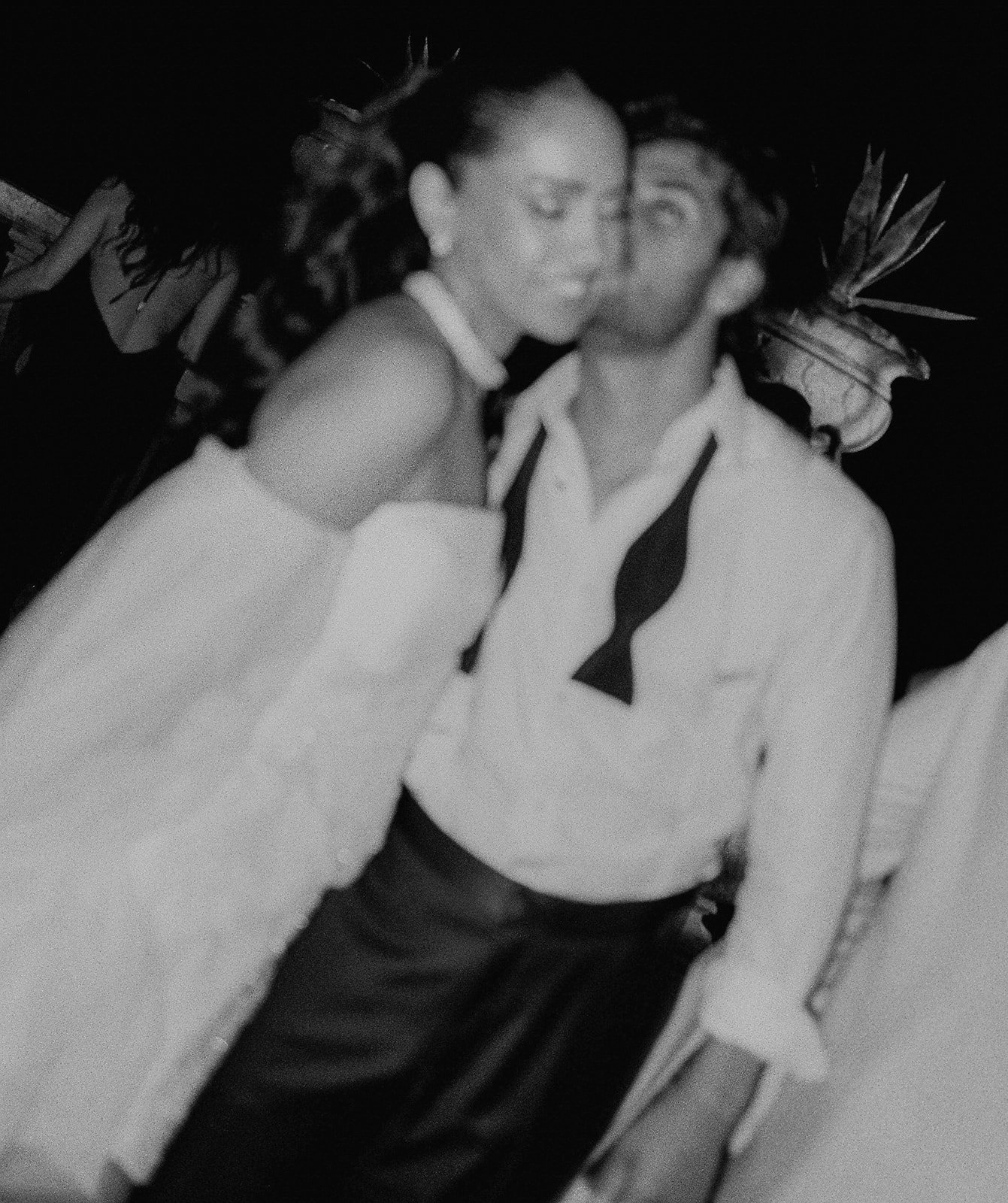 Black and white photograph of the newlyweds dancing at Palácio de Queluz, a motion blur capturing a spontaneous moment during the evening — wedding photography by The Lopes Photography