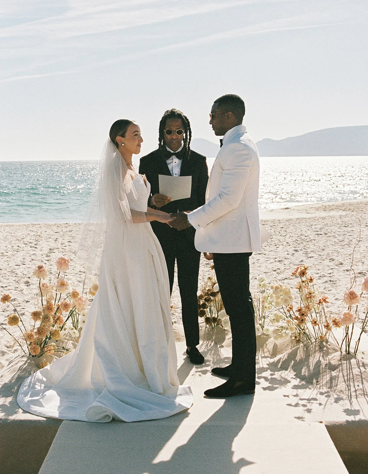 Andrea and Nick facing each other during their beach ceremony vows at a private villa wedding in Comporta | The Lopes Photography