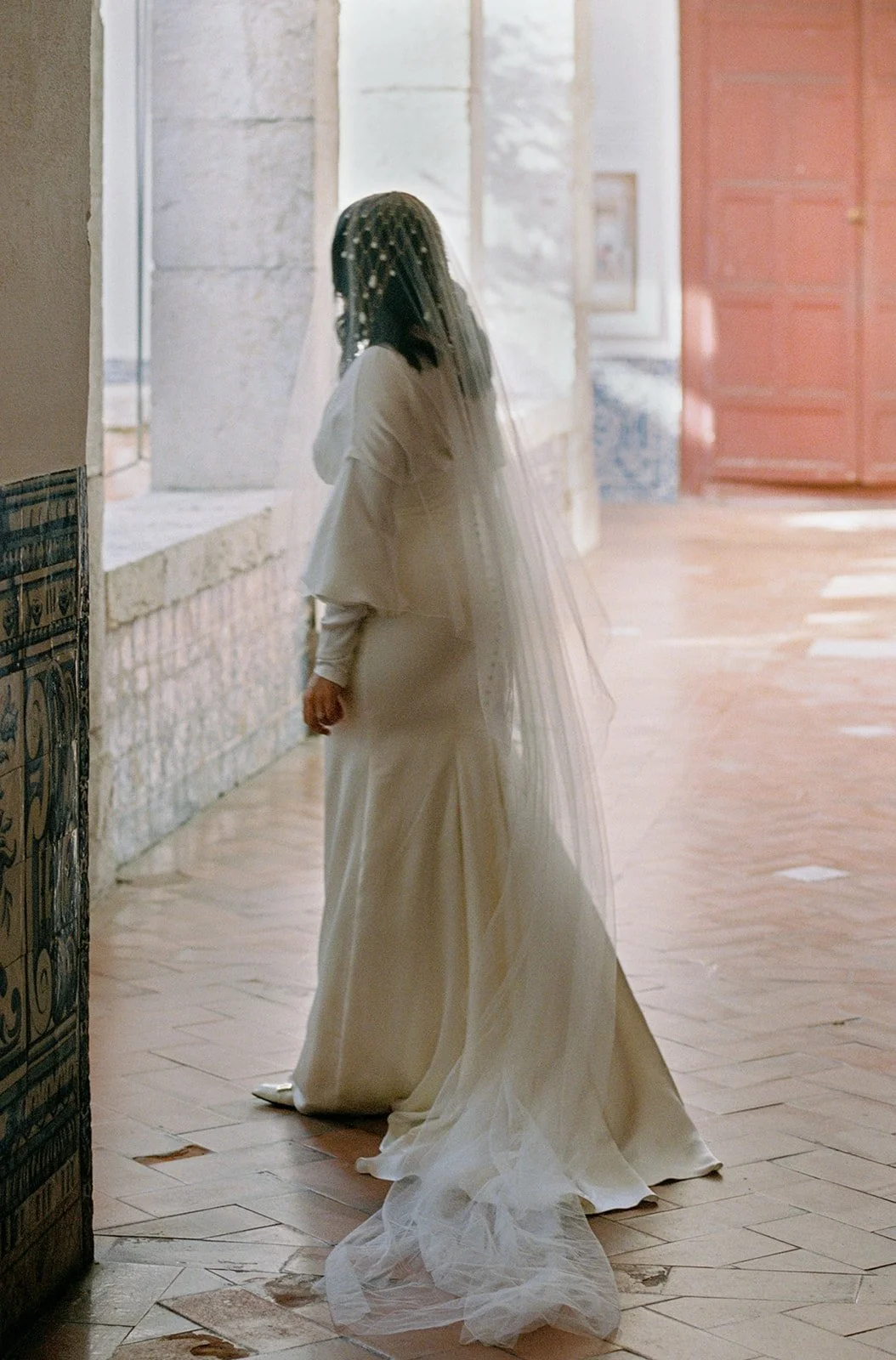 Film photograph of a bride by a window at Grémio Literário, Lisbon | The Lopes Photography