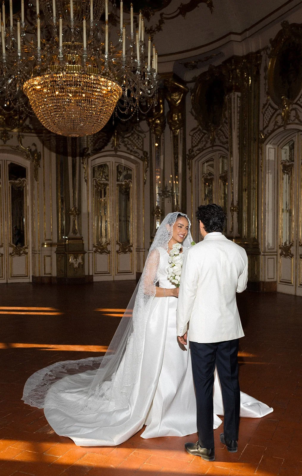 Newlyweds portrait in Palácio de Queluz golden ballroom, natural light — editorial photography by The Lopes Photography, published in Vogue Arabia