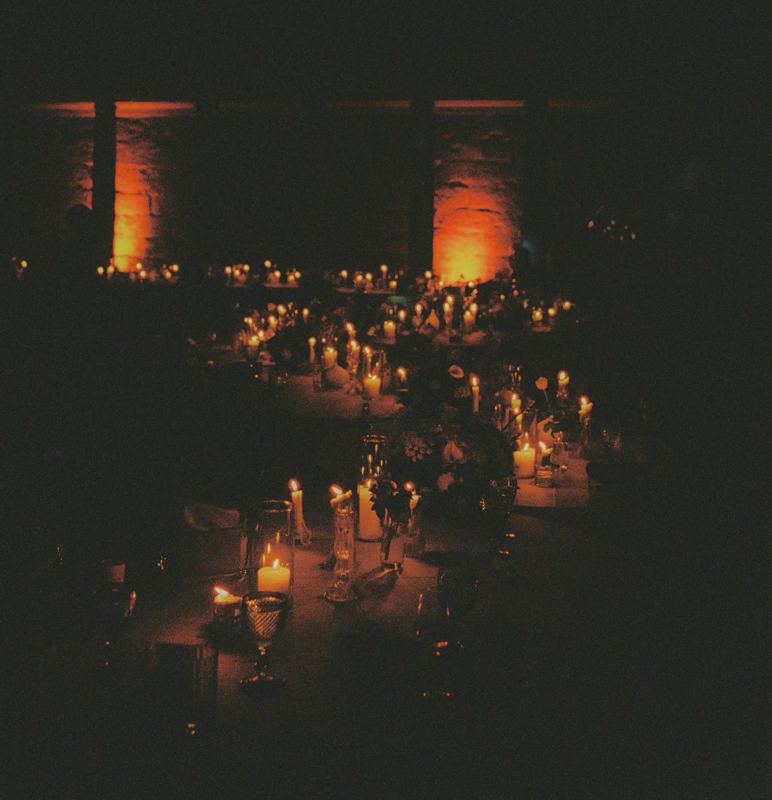 Candlelit reception with amber-lit stone columns, Mosteiro de Landim, destination wedding photography by The Lopes Photography